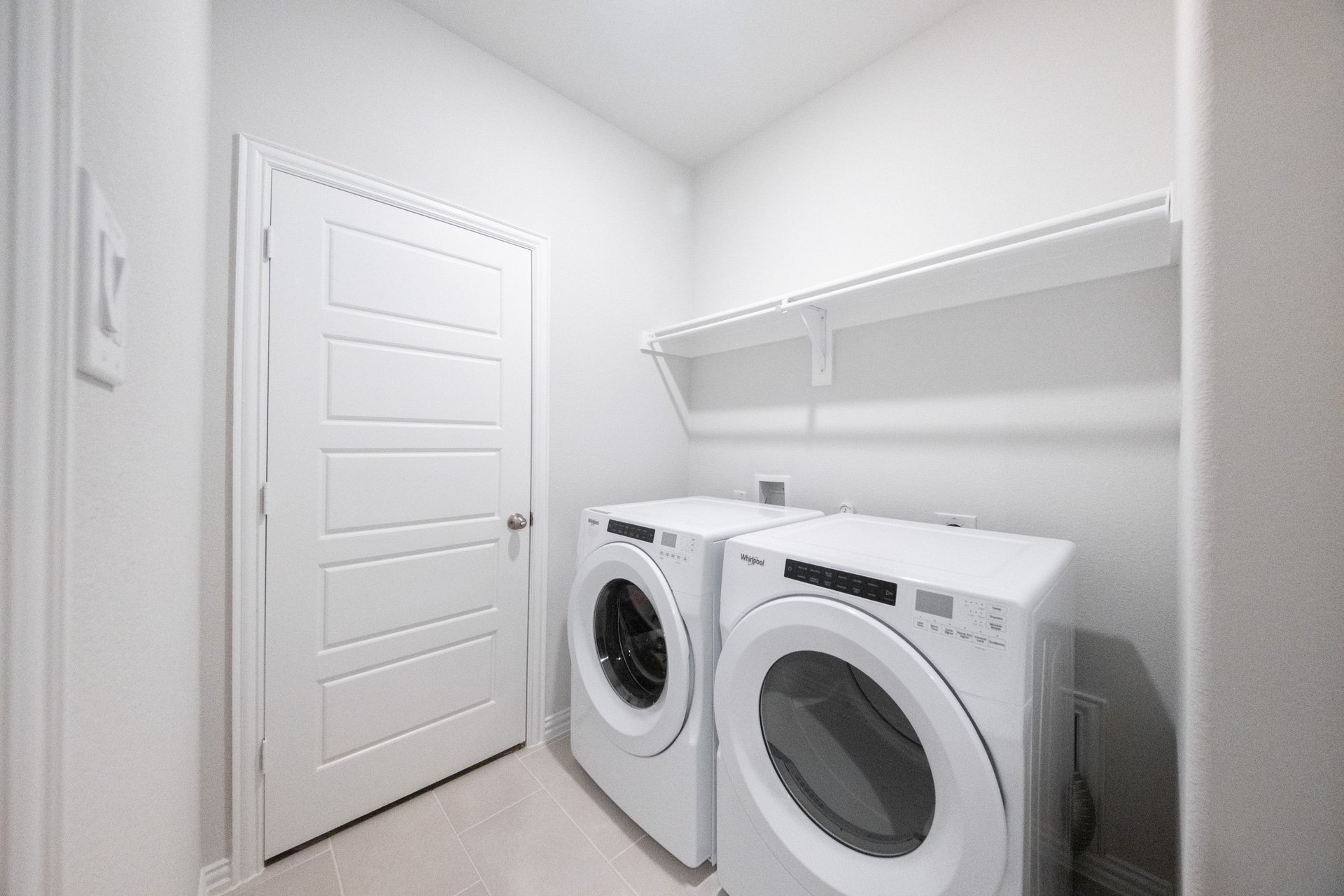 laundry room with tile floors, washer, and dryer