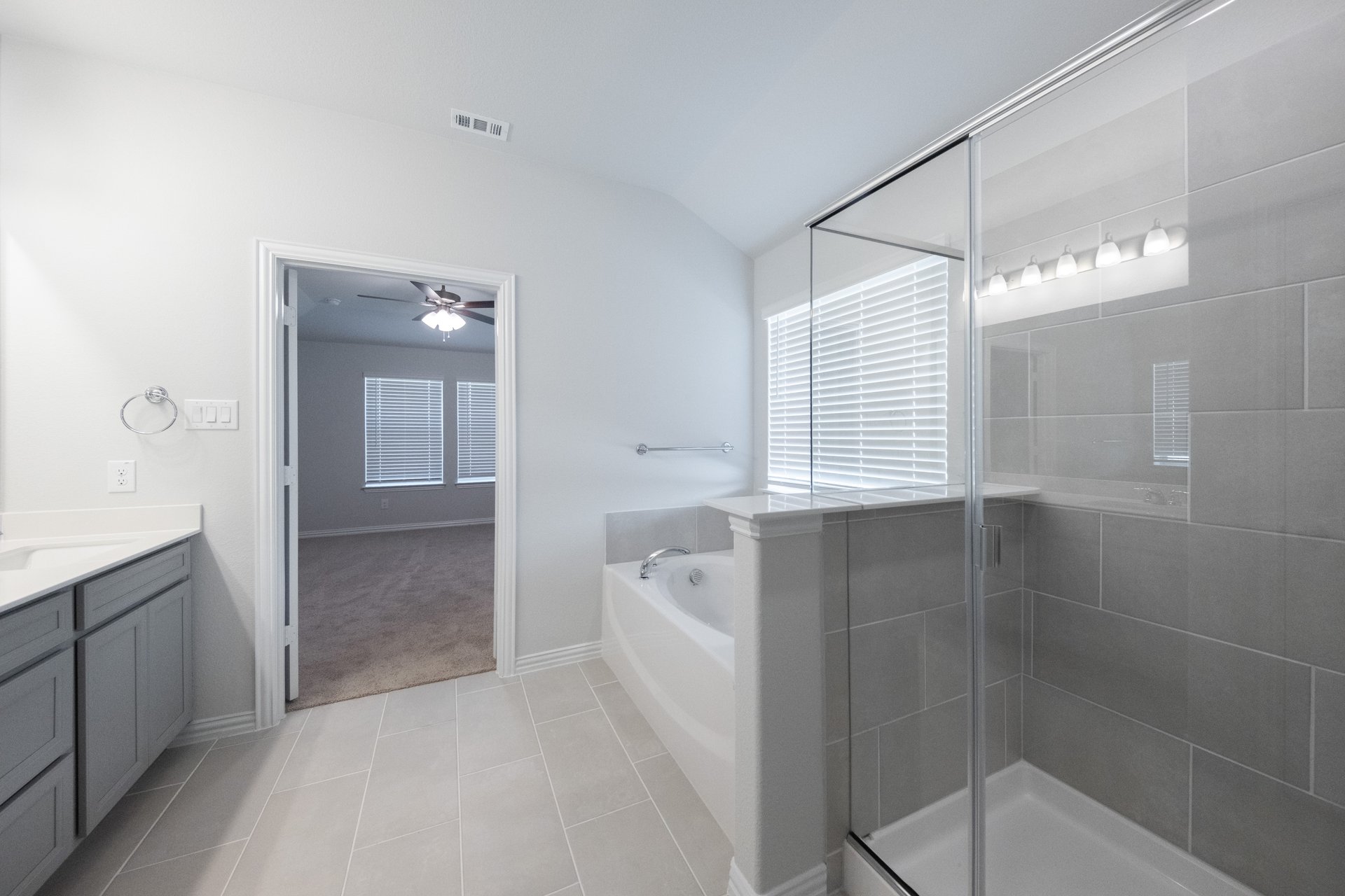 primary bathroom with walk-in shower and soaking tub
