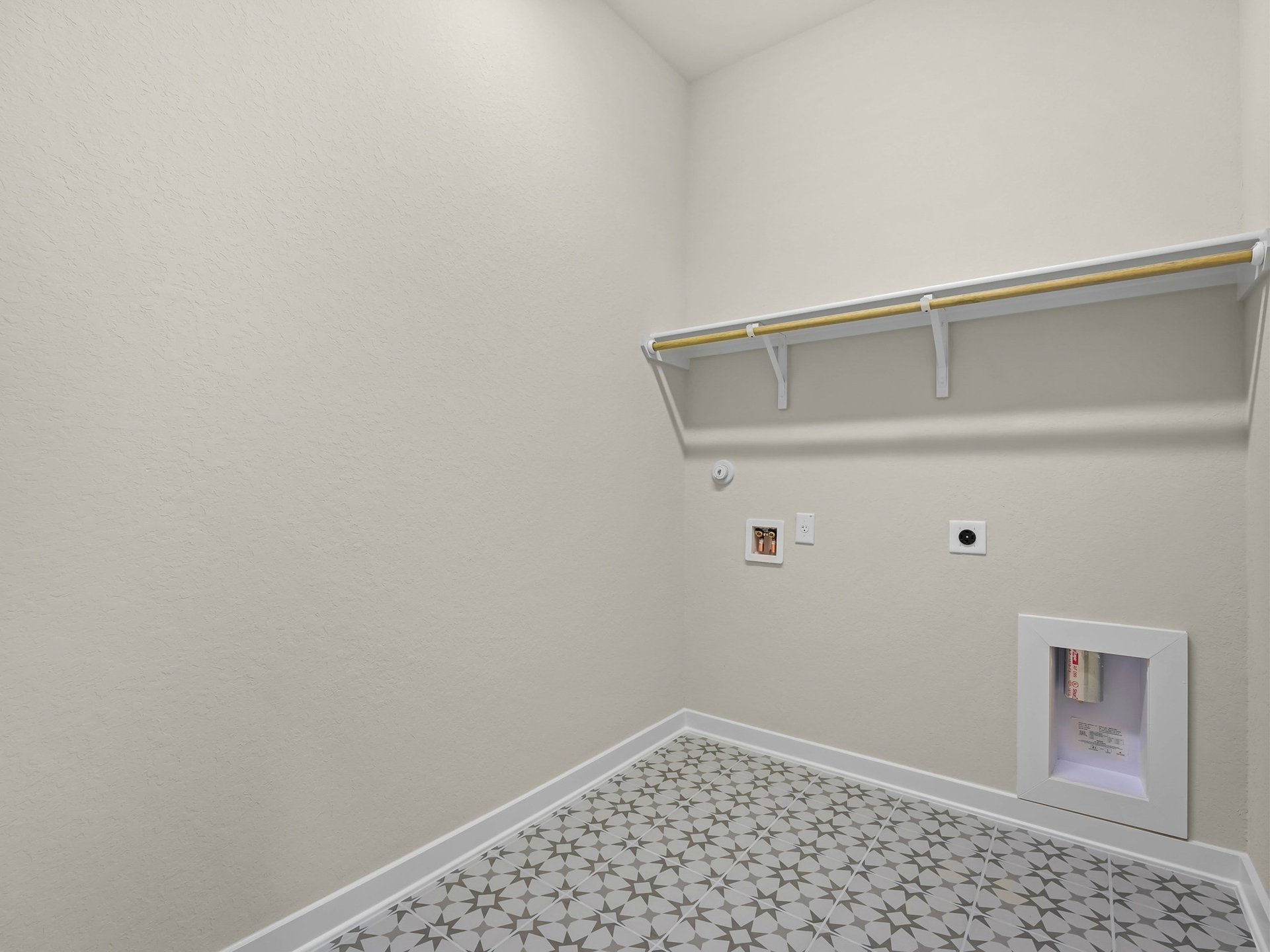laundry room with pattern flooring and storage space
