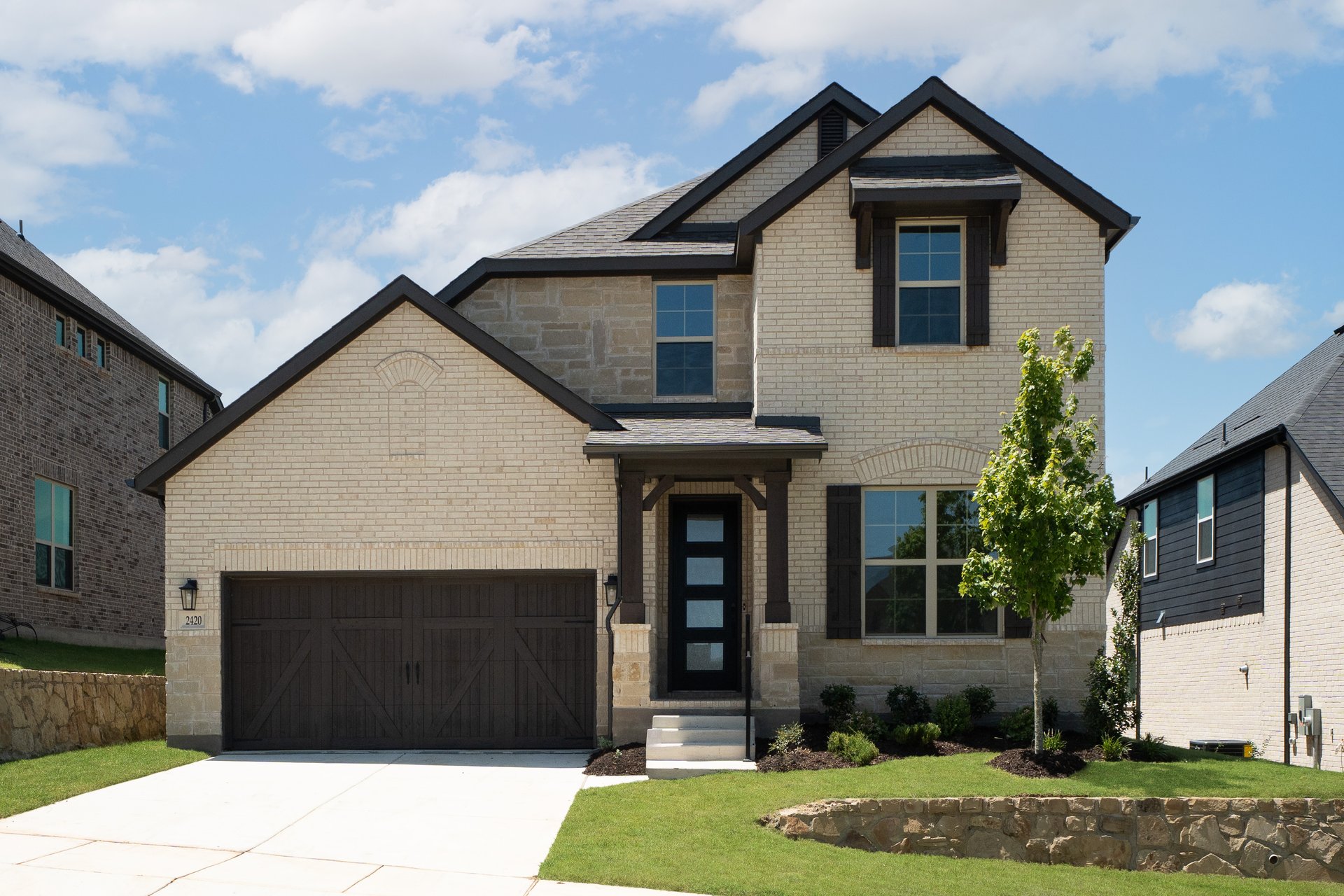 two-story home with brick and shutters