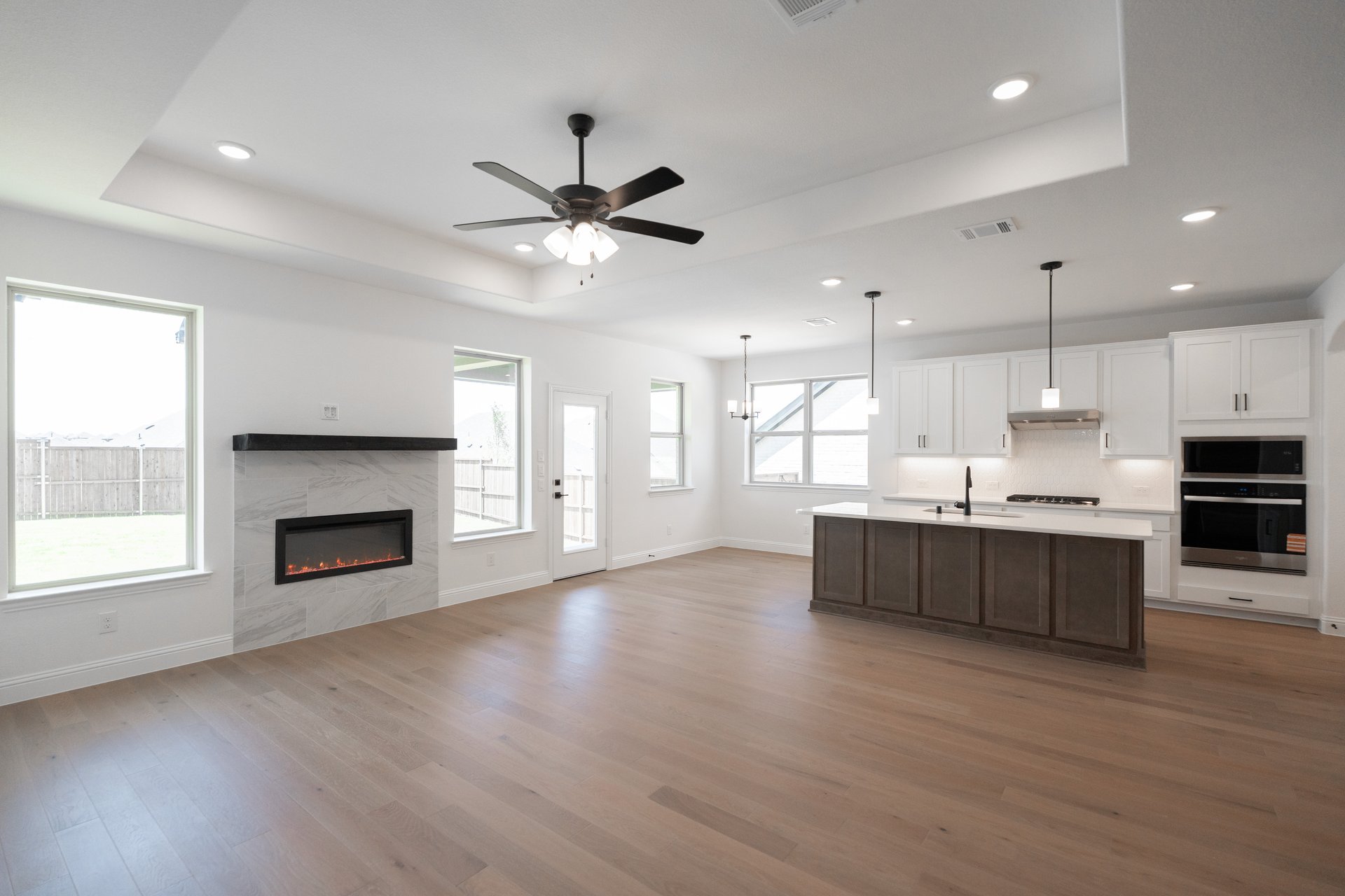 open great room with wood floors and fireplace