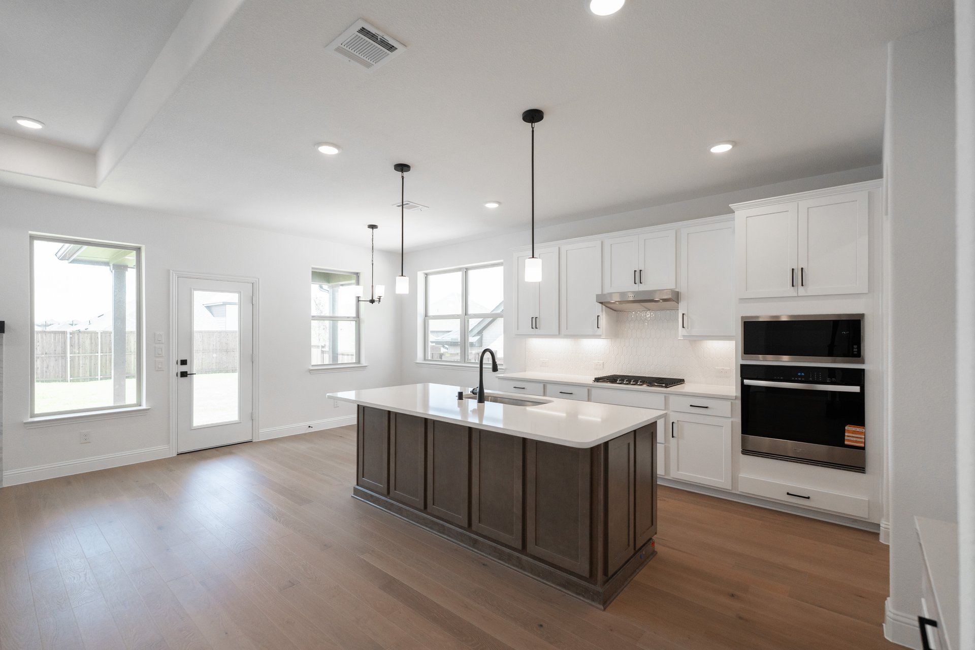 open kitchen with wood floors and island