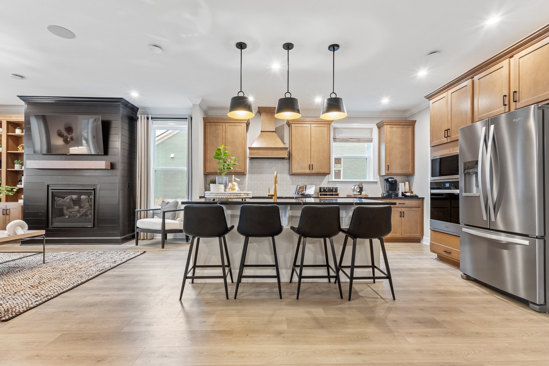 kitchen area with hardwood floors, a large island, and four black barstools