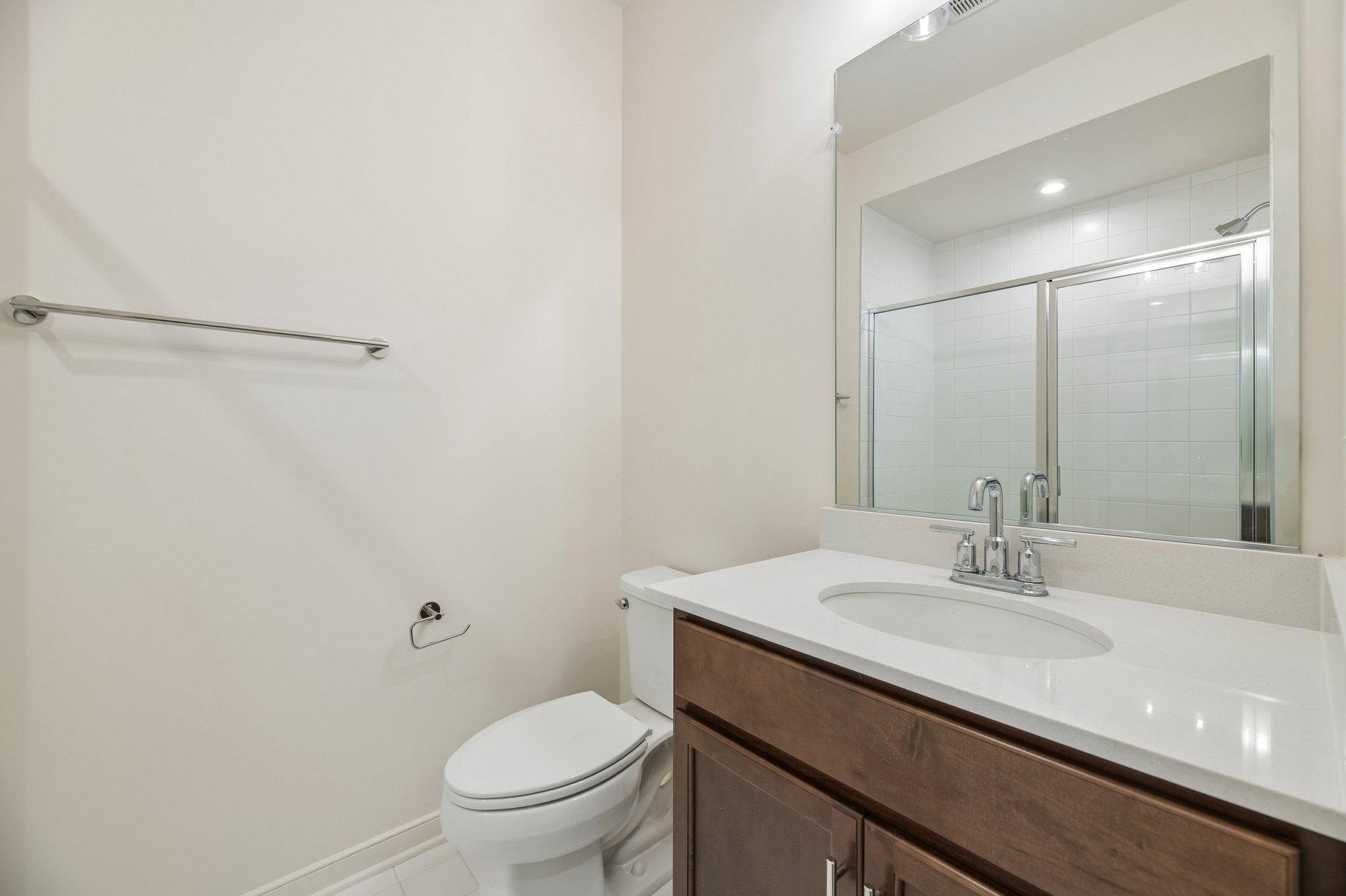 secondary bathroom with a walk-in shower
