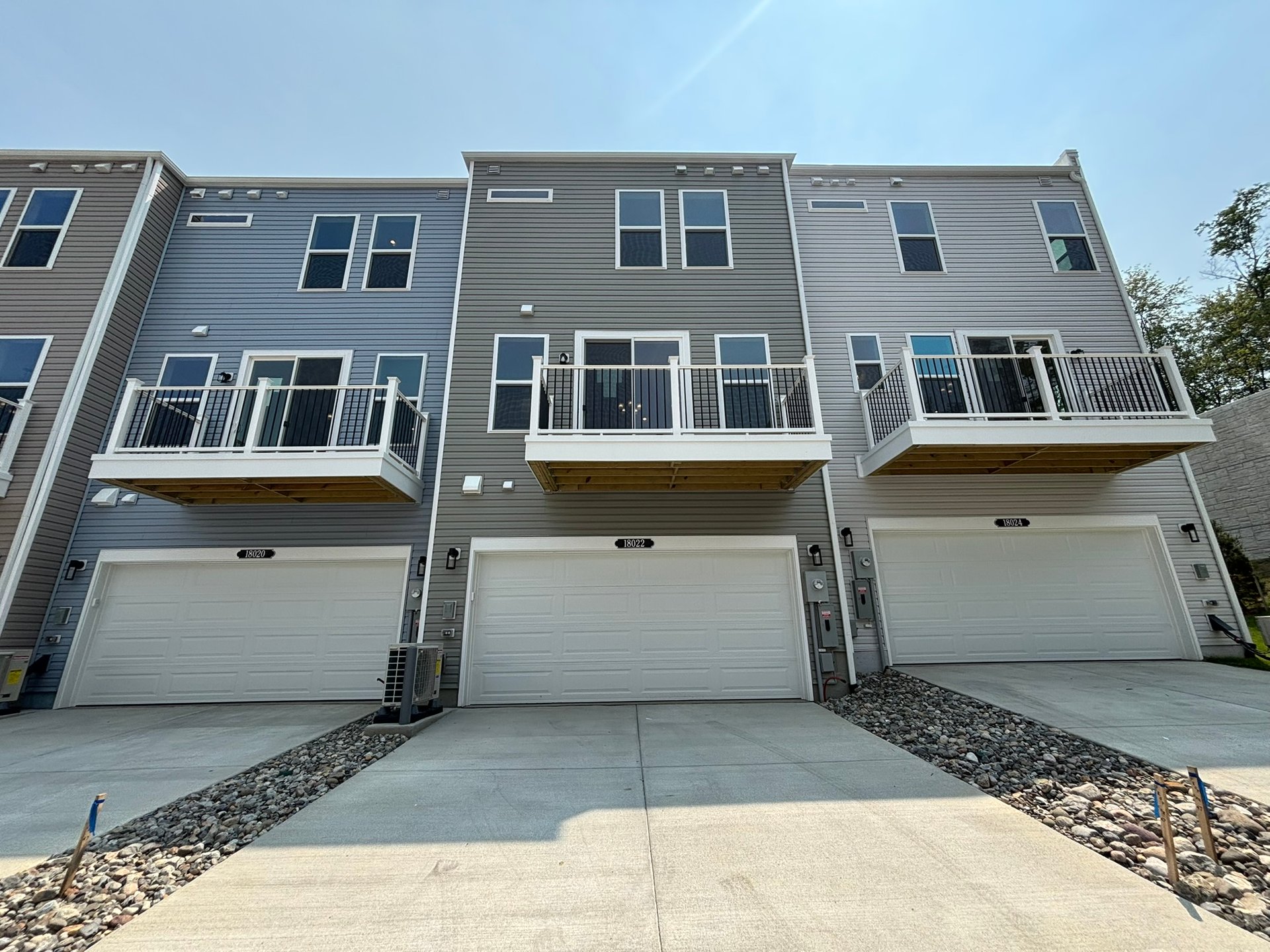 townhome exterior with a 2-car garage and deck
