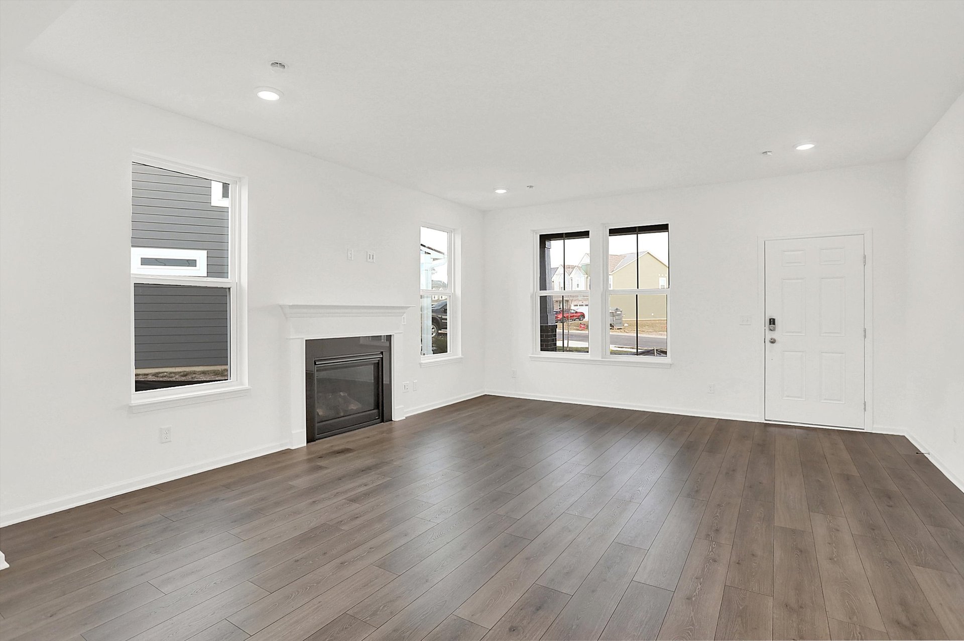 great room with fireplace and wood plank flooring 