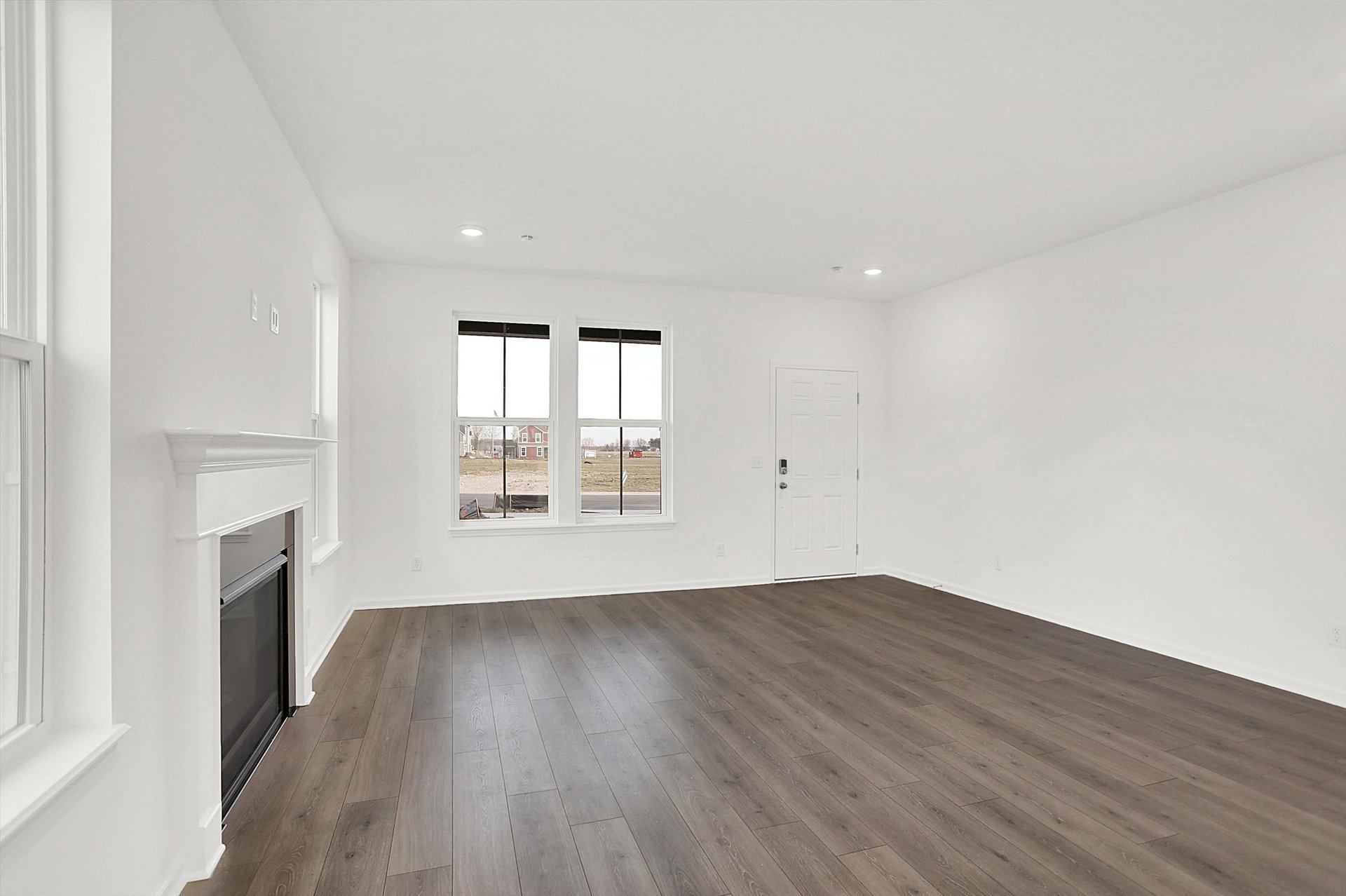 great room with wood plank flooring and windows letting in natural light