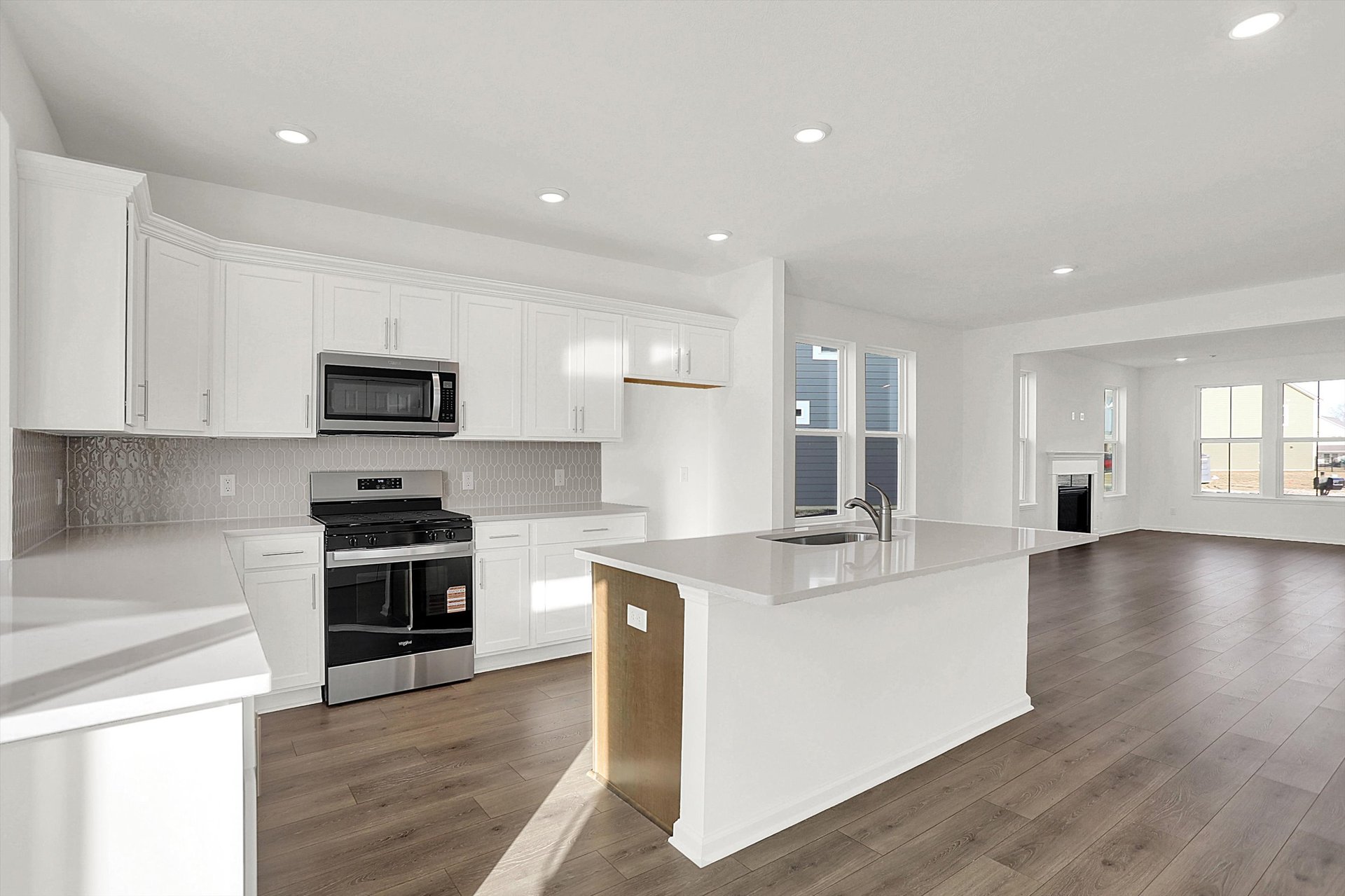 kitchen with white cabinets and island with built-in sink