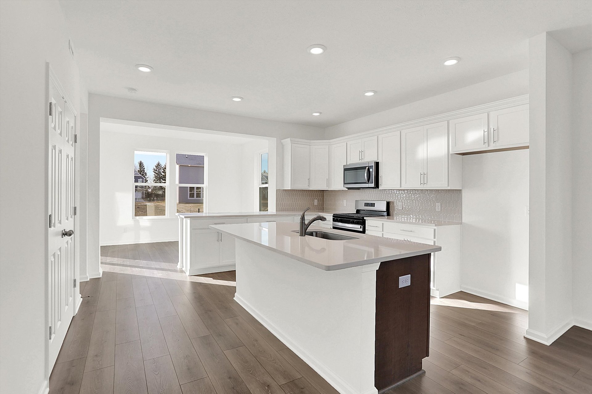 kitchen with white cabinets and island with built-in sink