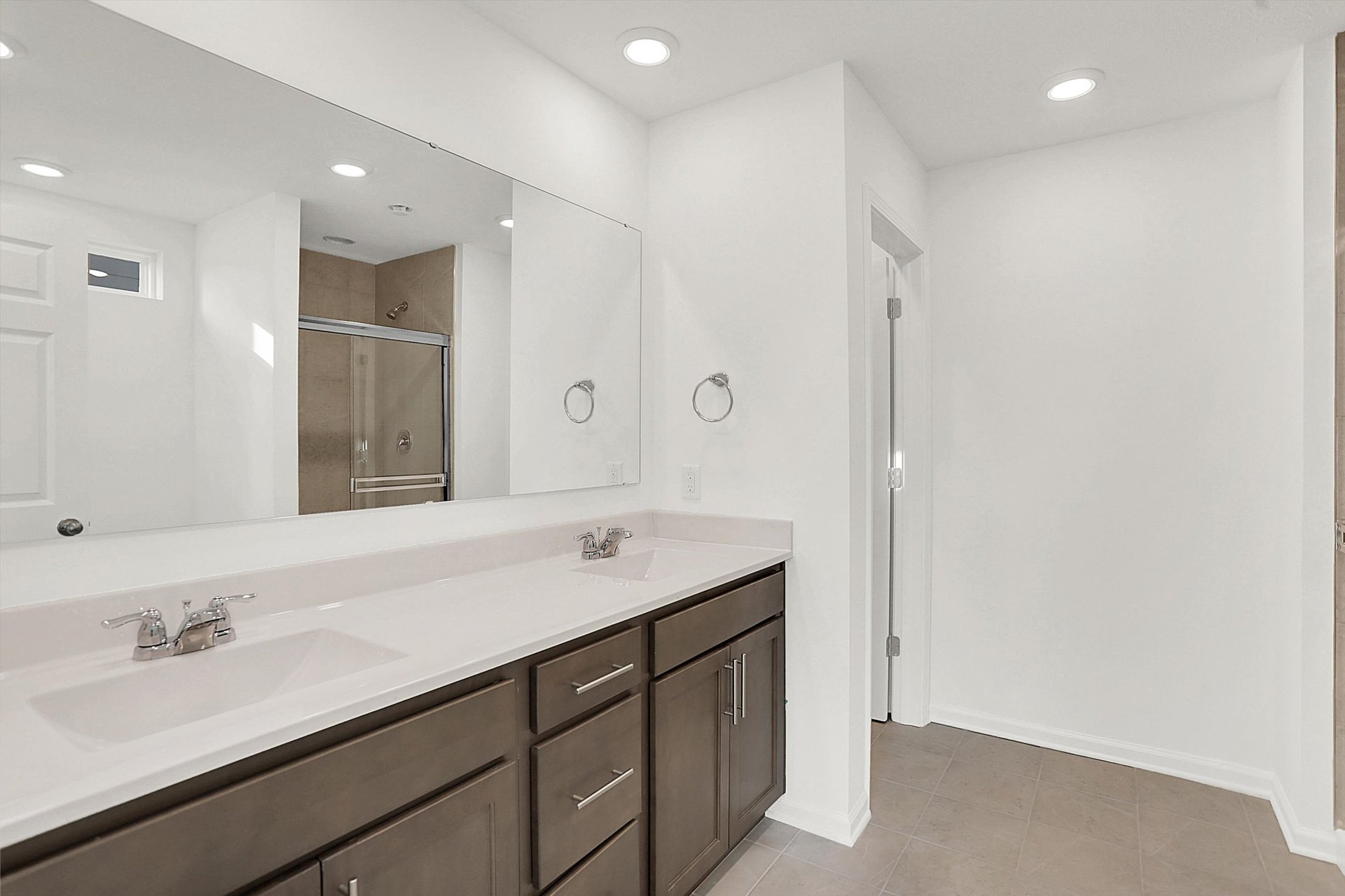 bathroom with dark wood vanity and dual sinks