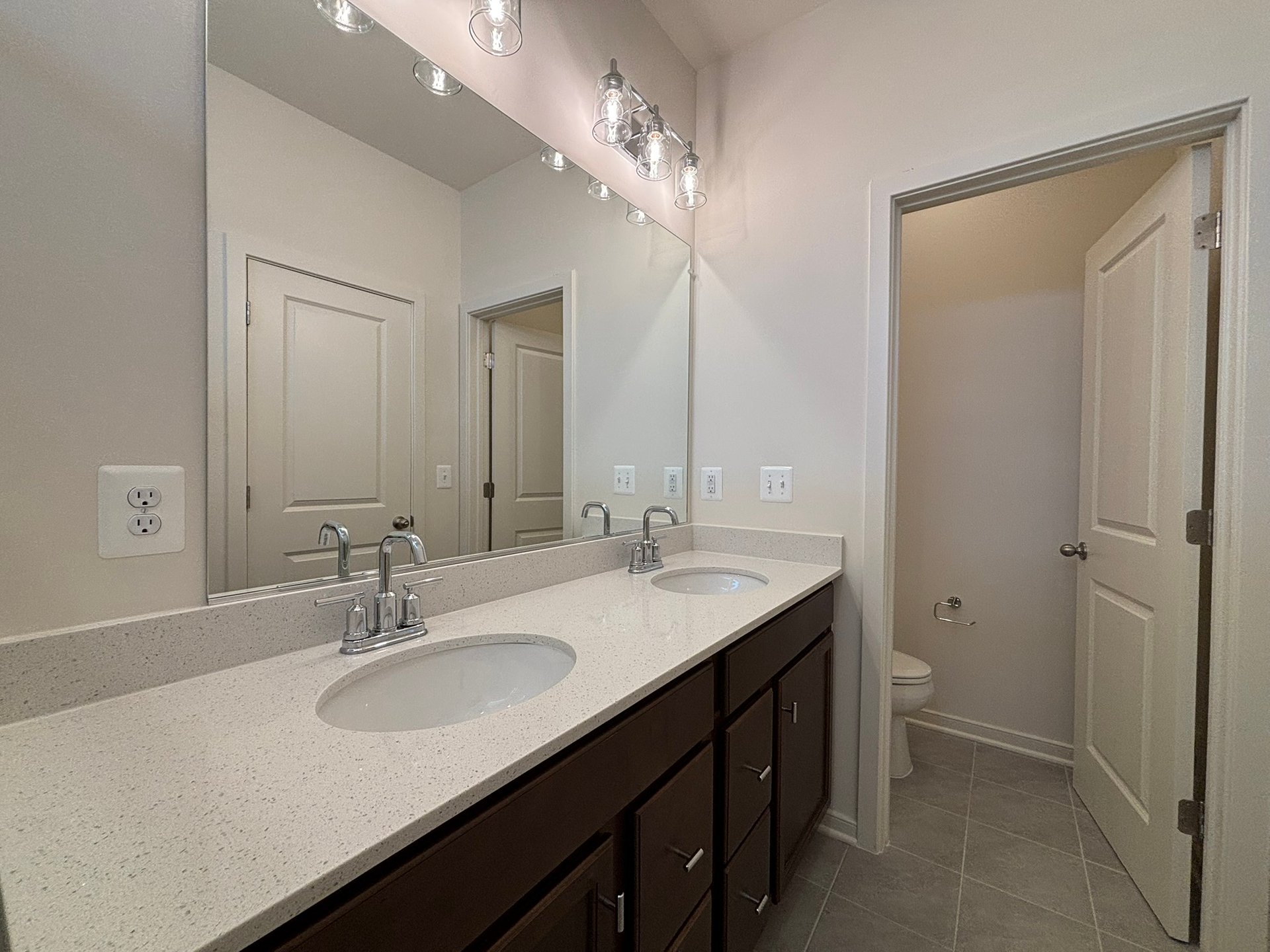 primary bathroom with dual vanities