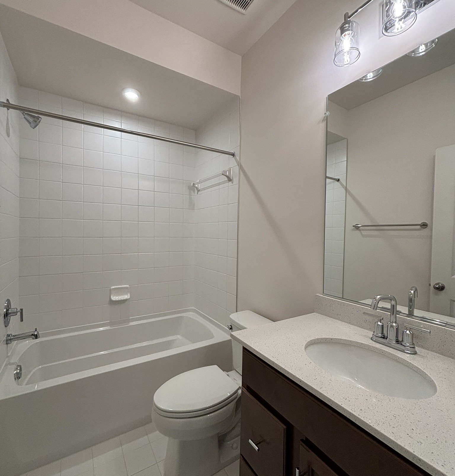 secondary bathroom with a shower and tub combo