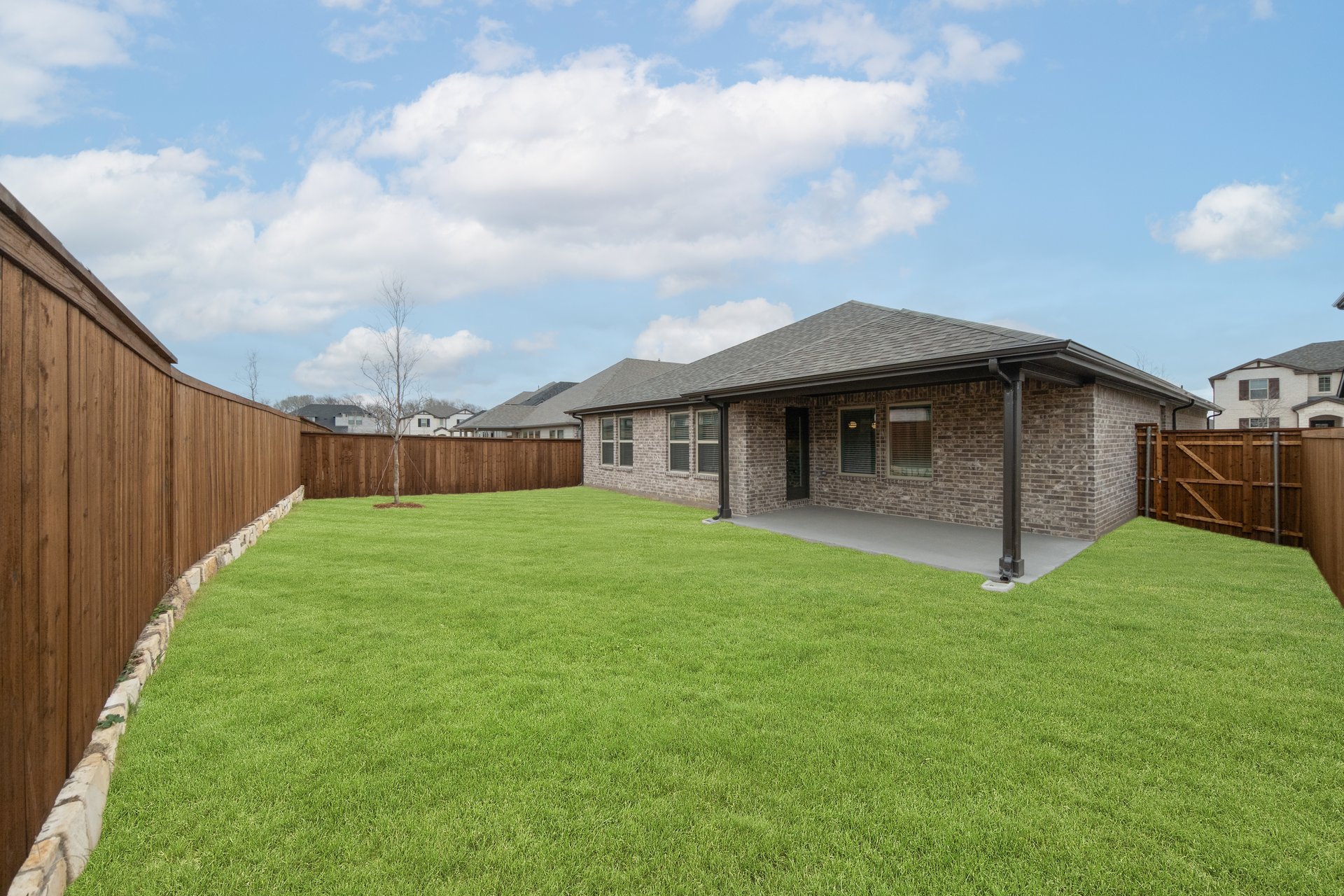 backyard with grass and covered patio