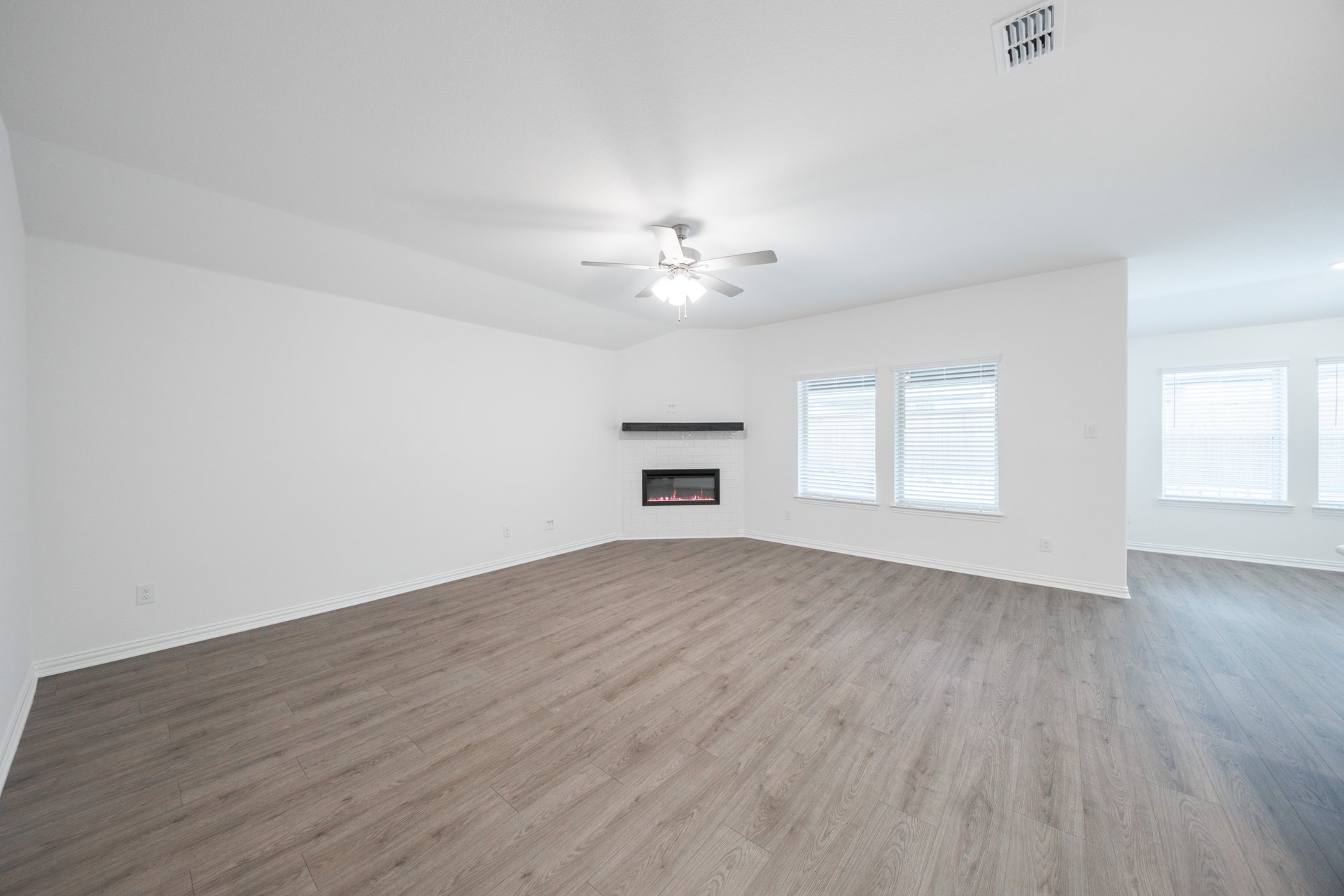 great room with fireplace and hard wood flooring