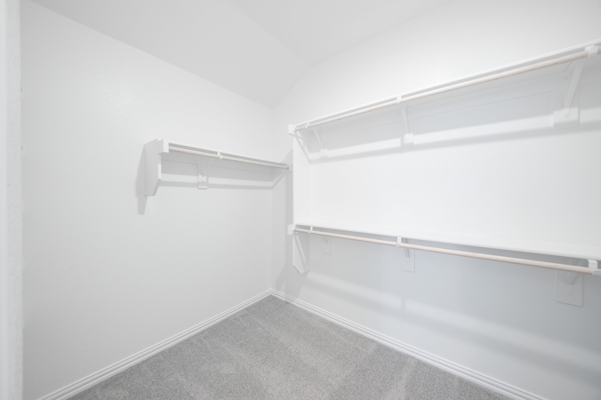 primary closet with carpet and white shelves