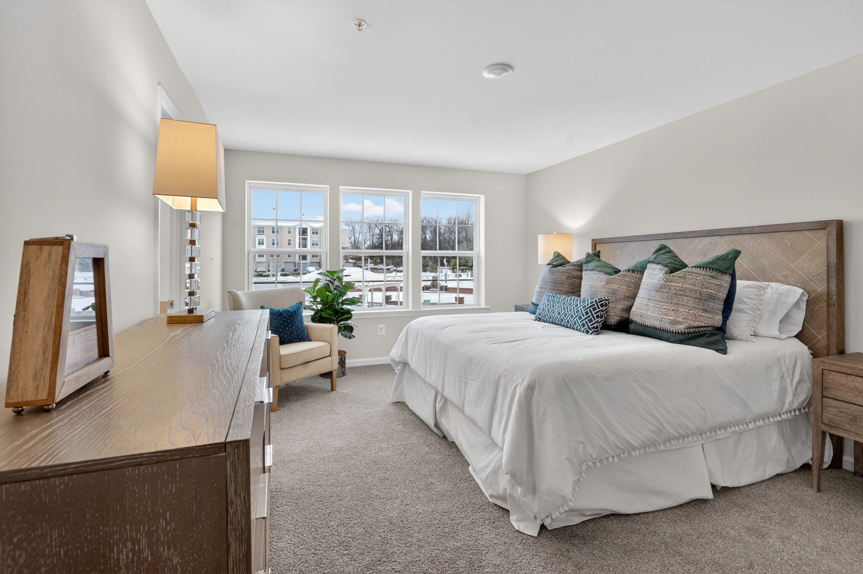 primary suite with a king-sized and carpet