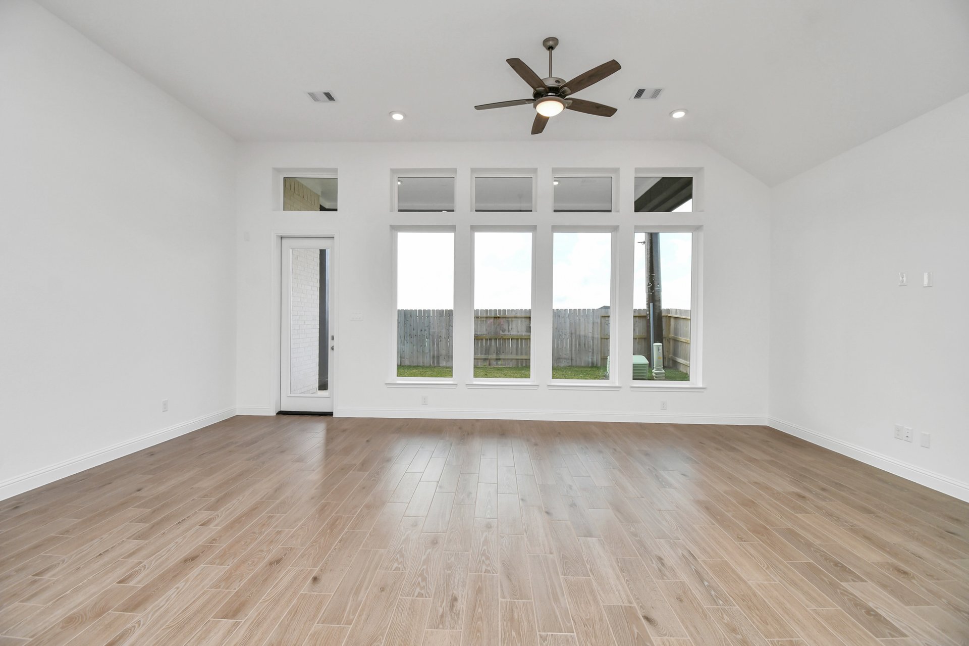 Great room with four windows.