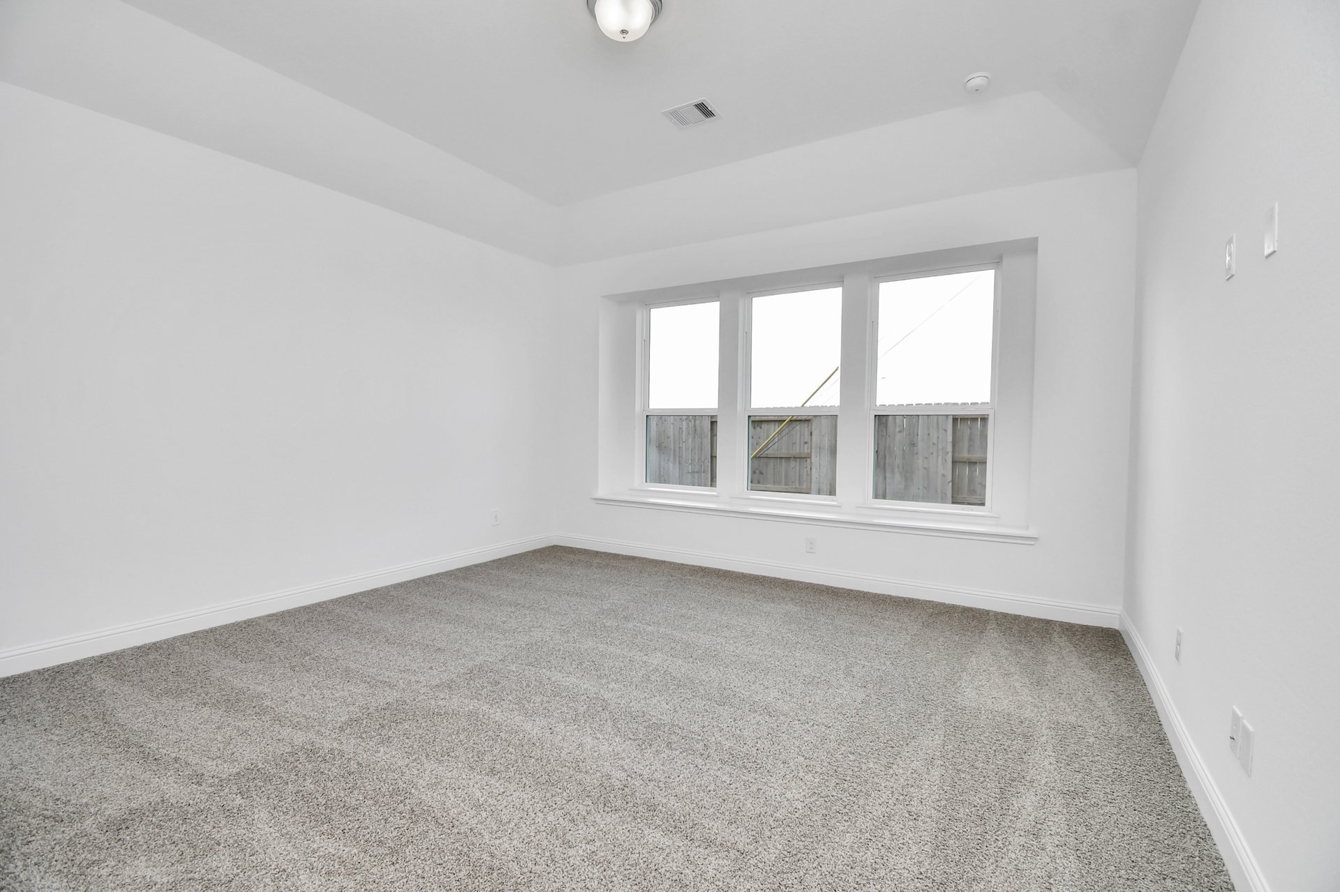 Primary bedroom with carpet 