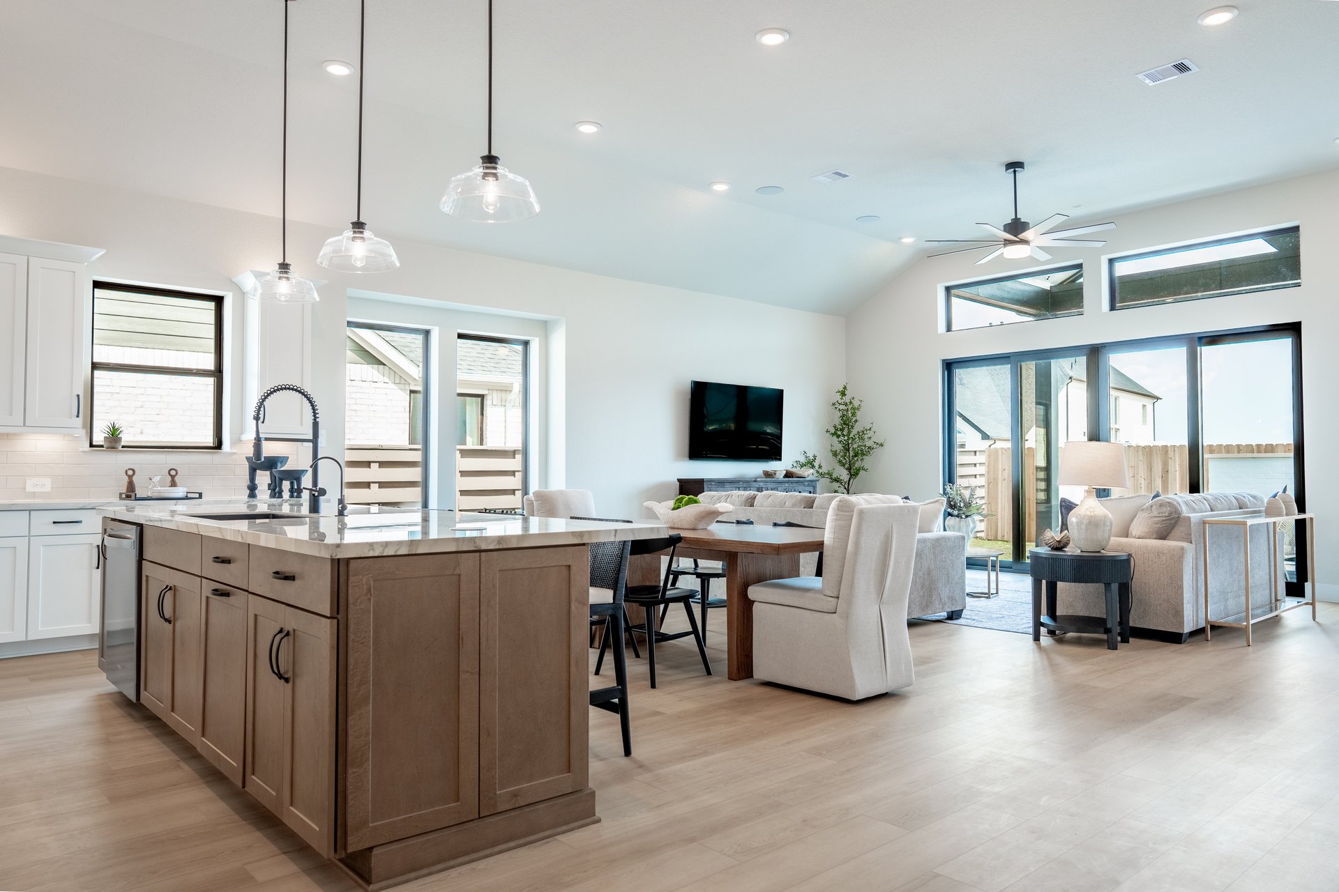 great room with tv and ceiling fan