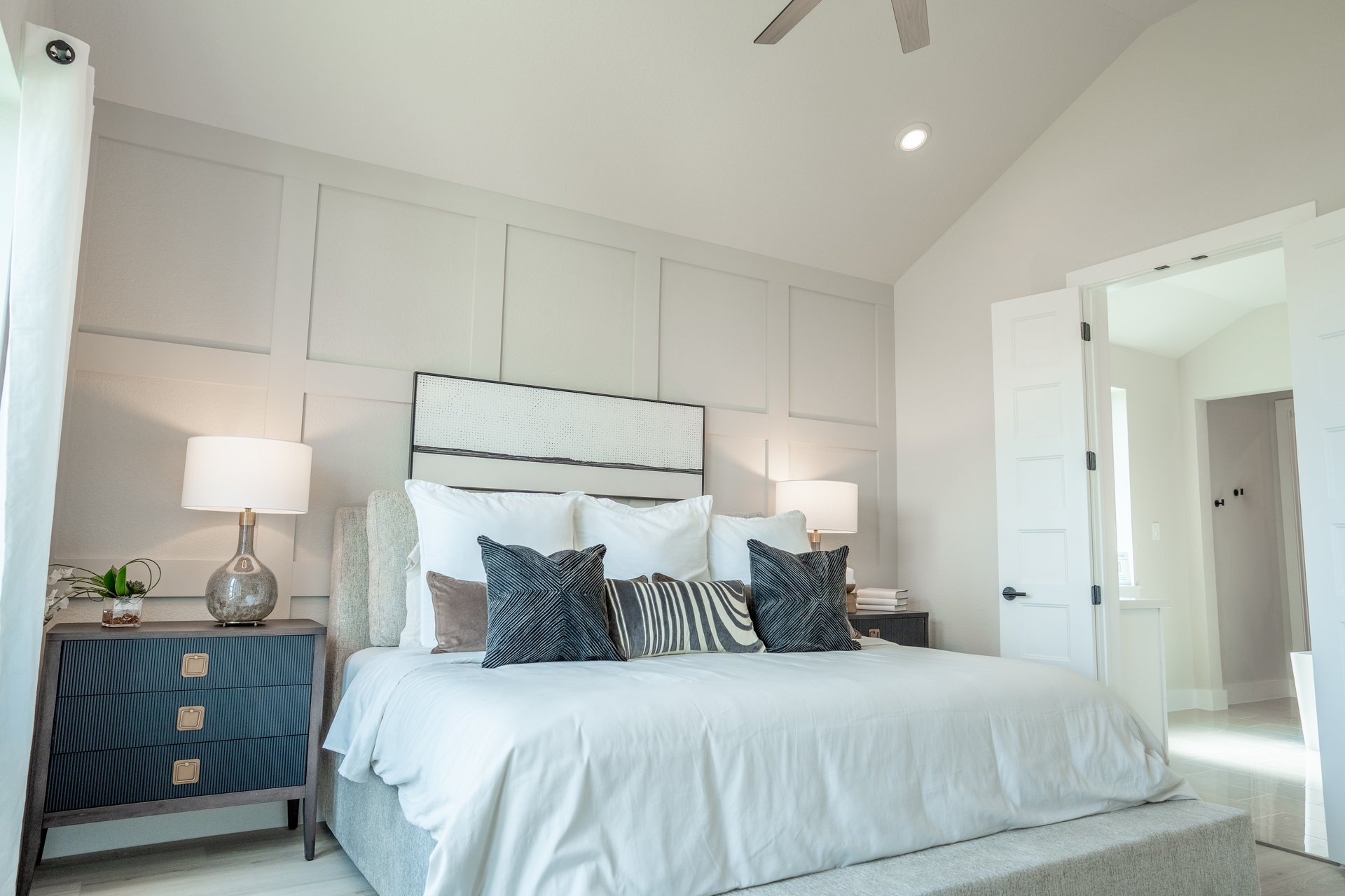 room with white bedding and art