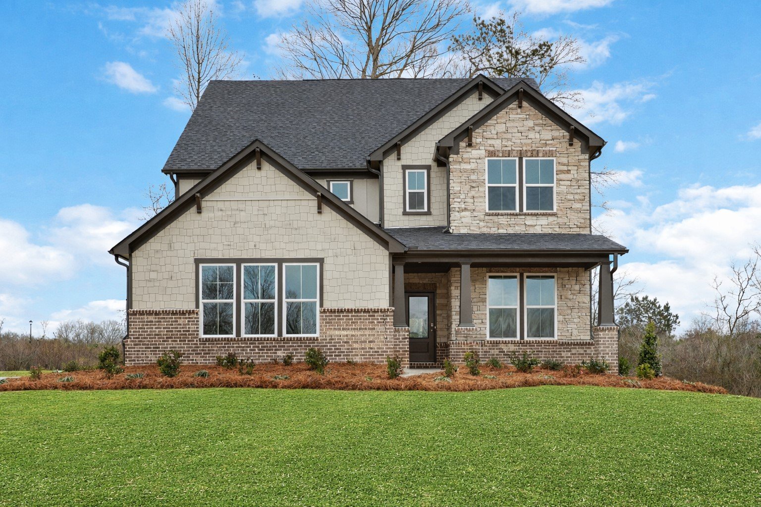 front of 2-story home with light siding and brick