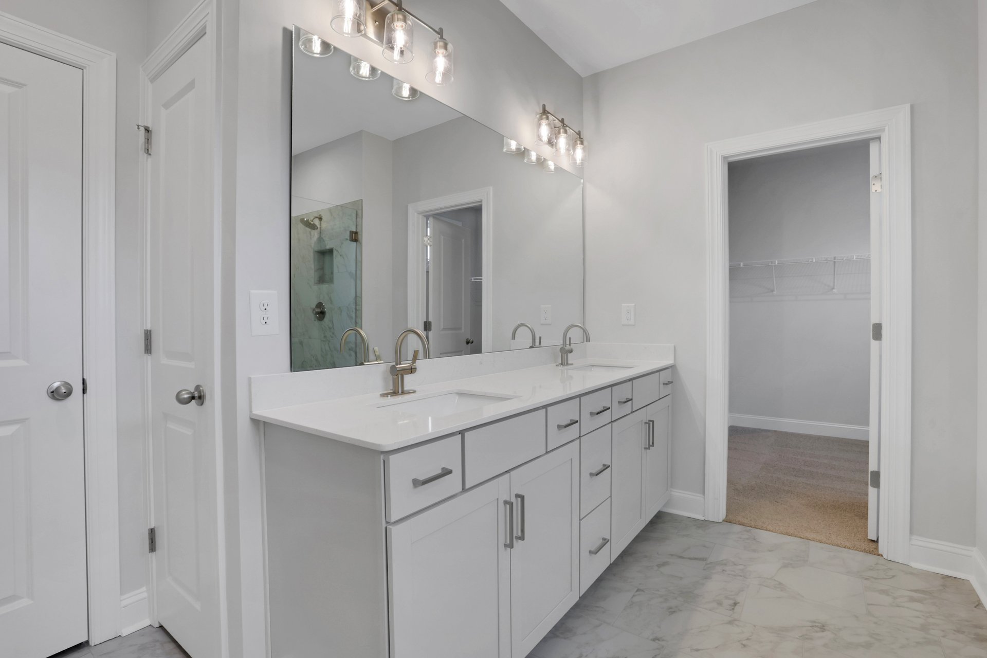 primary bathroom with gray cabinets and tile floors