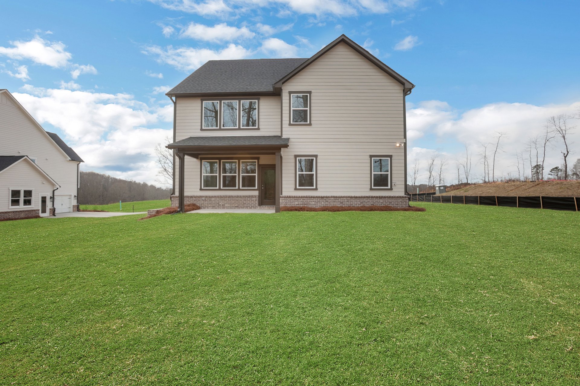 back of 2-story home with private backyard