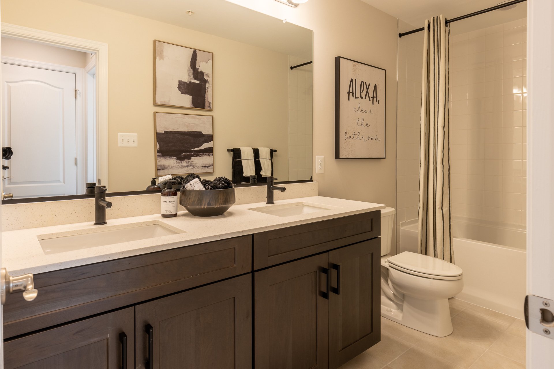 secondary bathroom with dual vanities