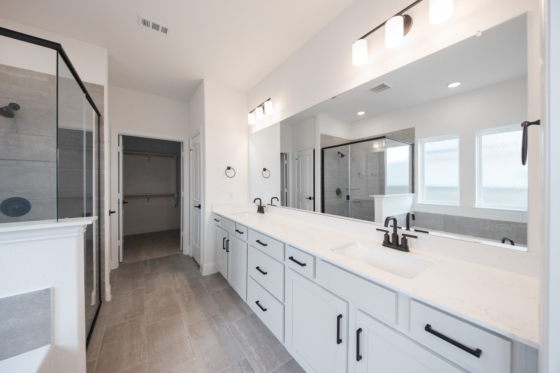 bathroom with white countertops and two sinks 