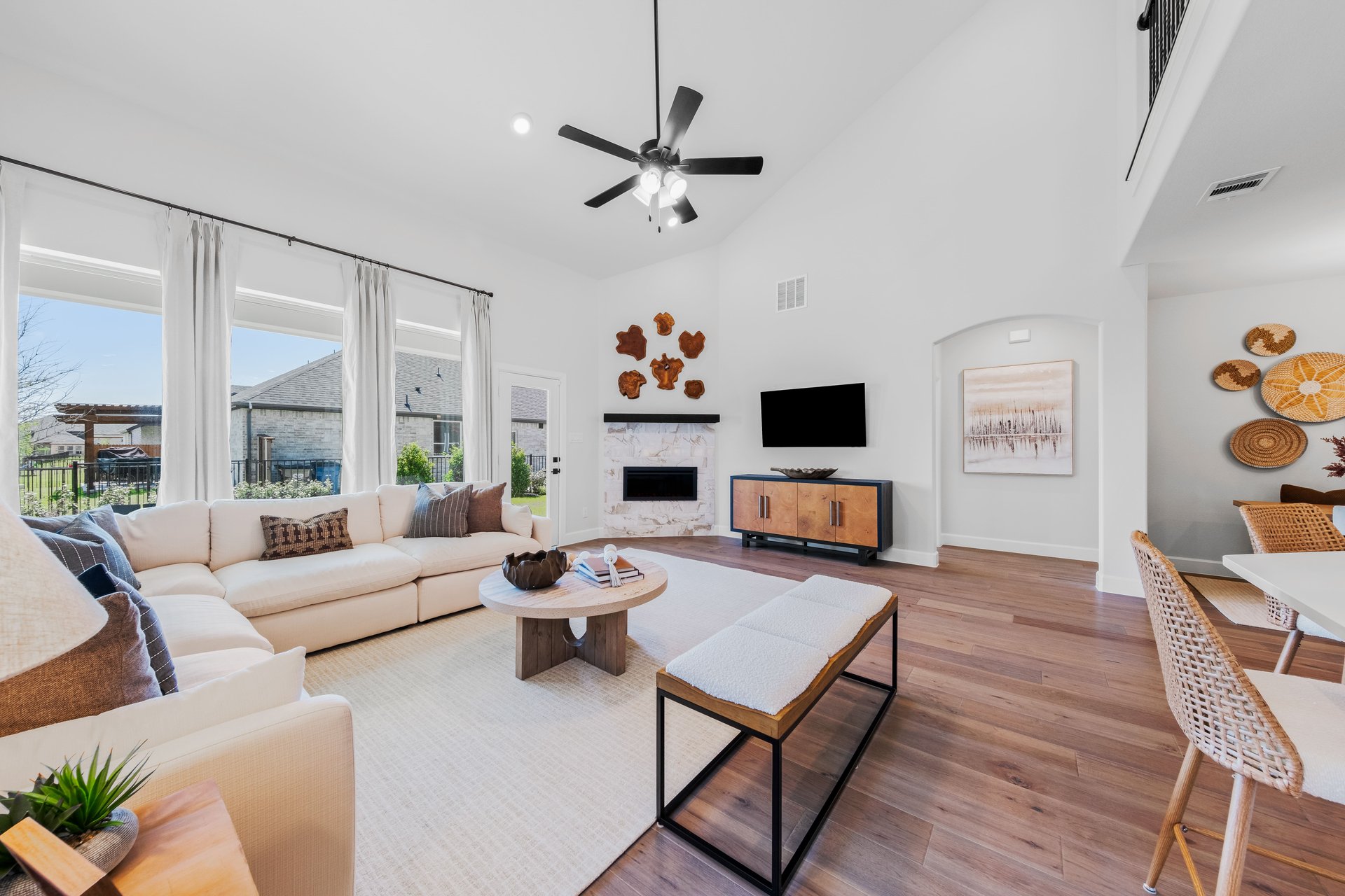 open great room with wood floors and ceiling fan