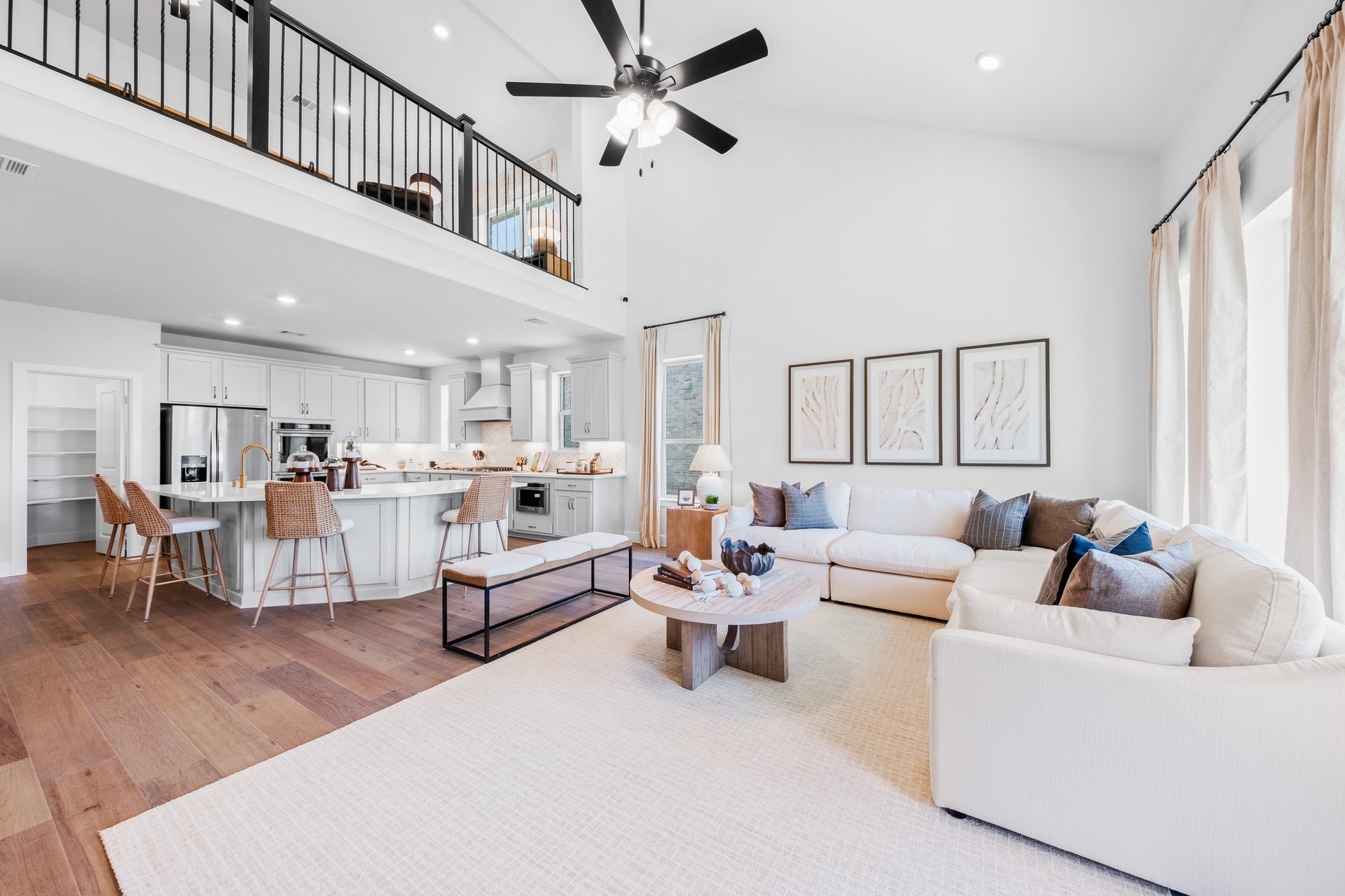 open great room with wood floors and ceiling fan