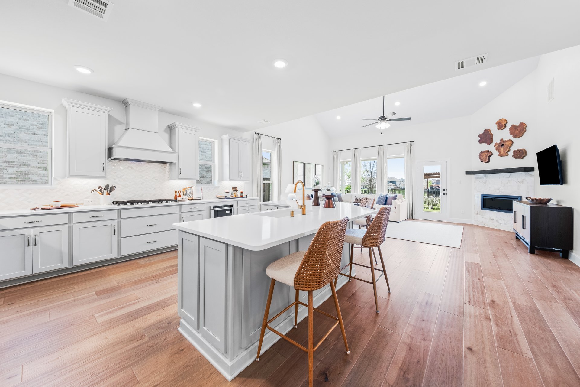 open kitchen with wood floors and white cabinets
