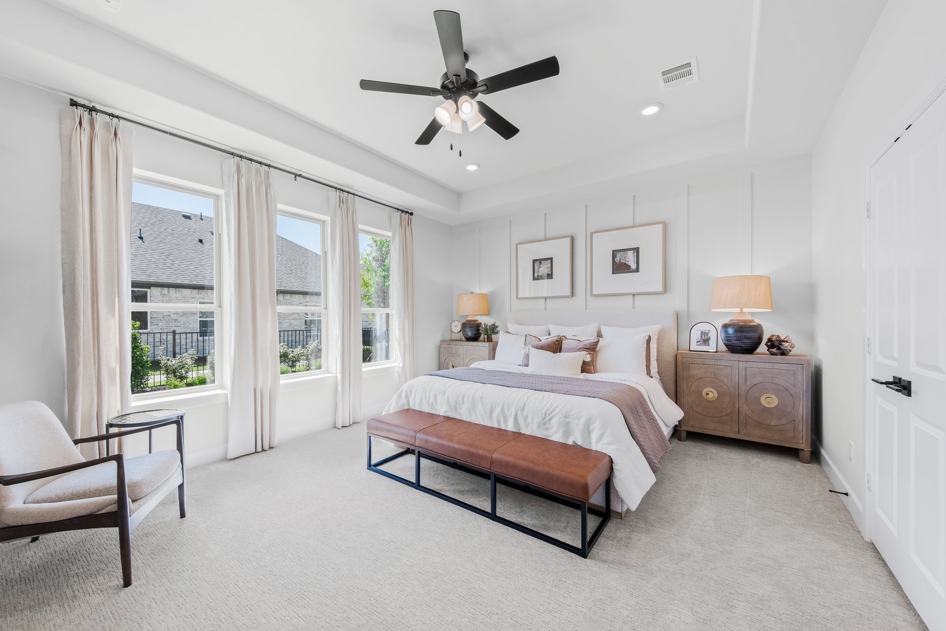 primary bedroom with carpet and windows