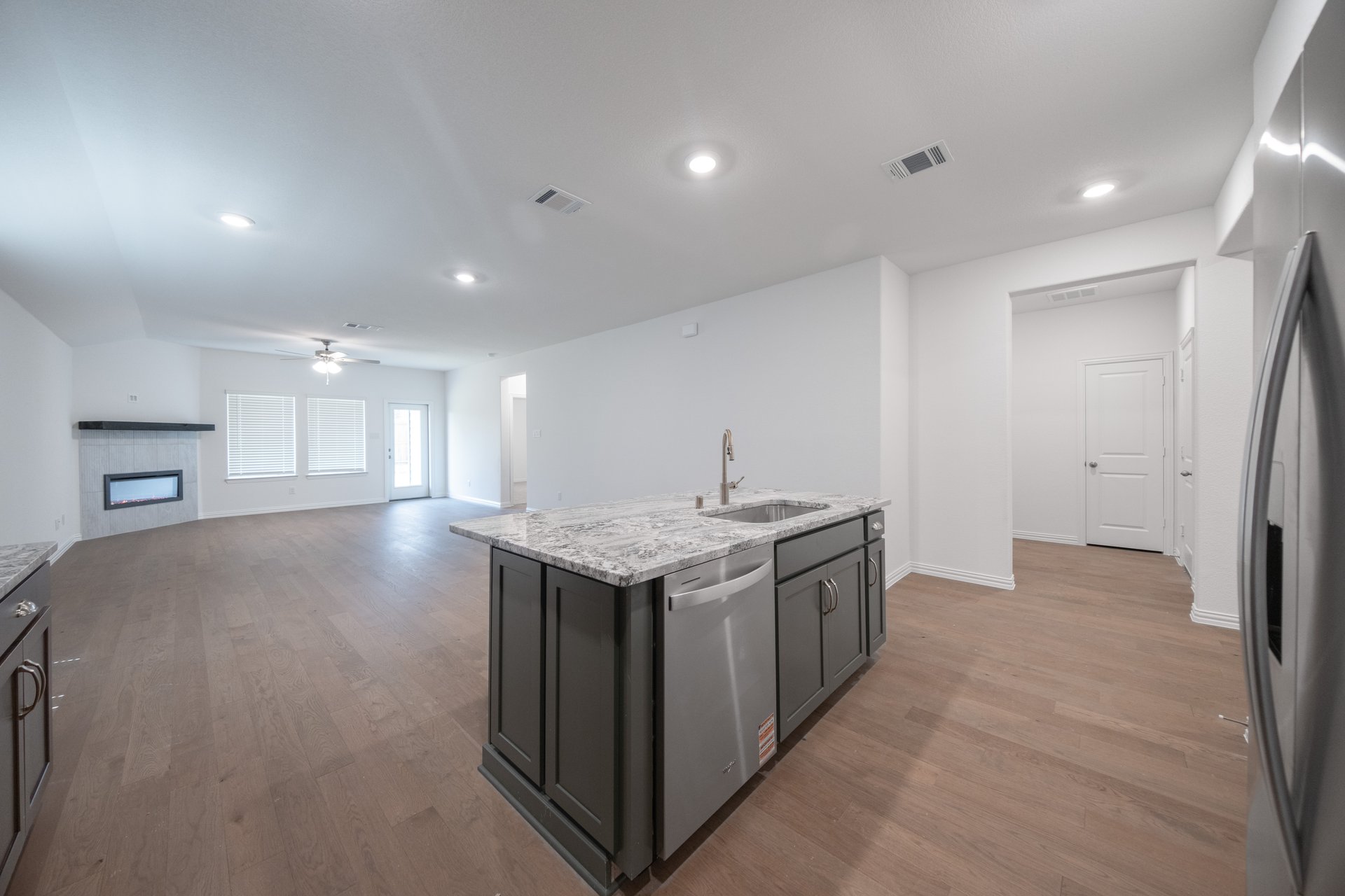 open kitchen with wood floors and island