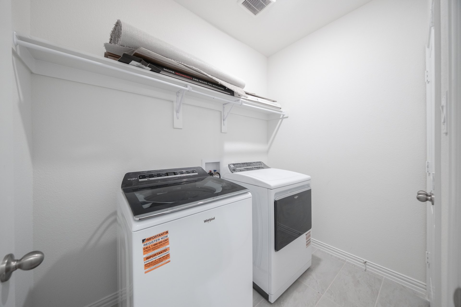 laundry room with tile floors, washer, and dryer
