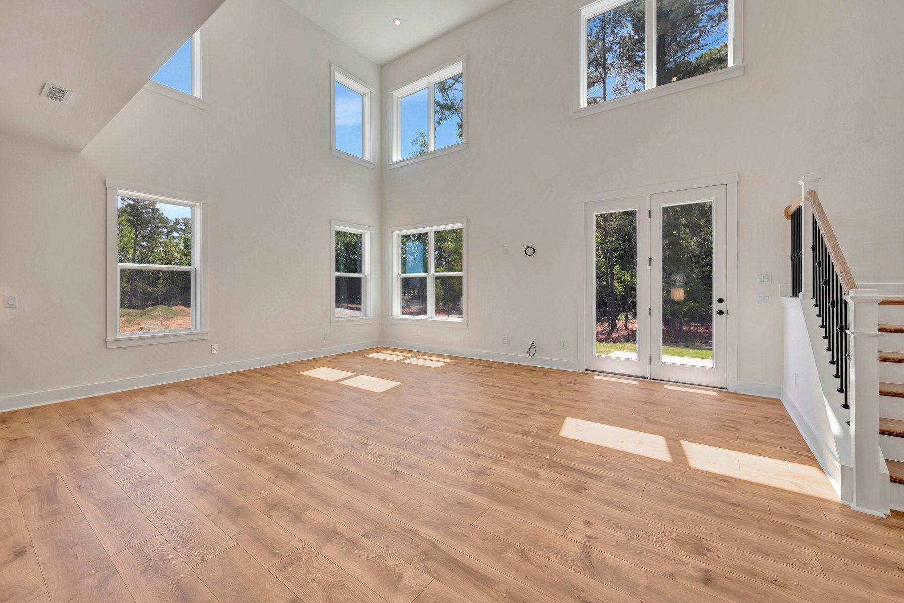 two-story great room with multiple windows