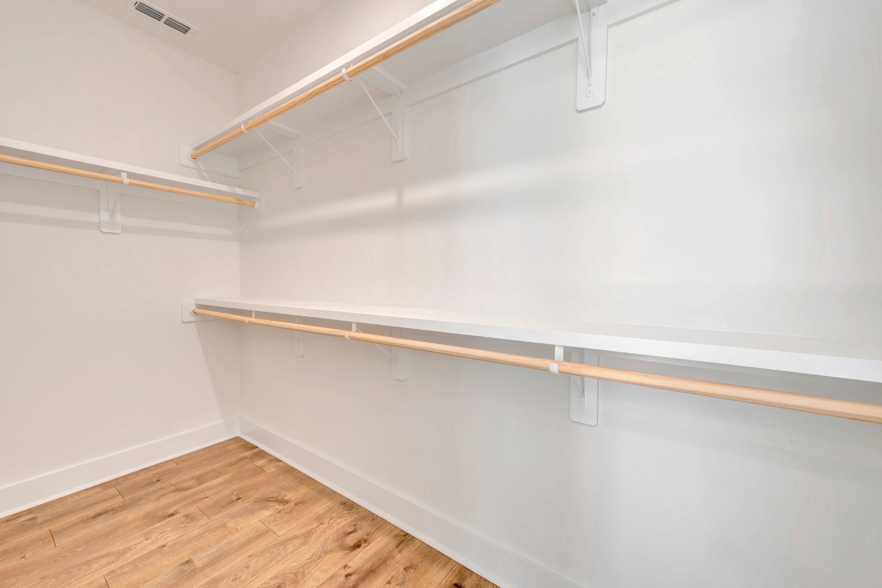 primary closet with wooden shelves