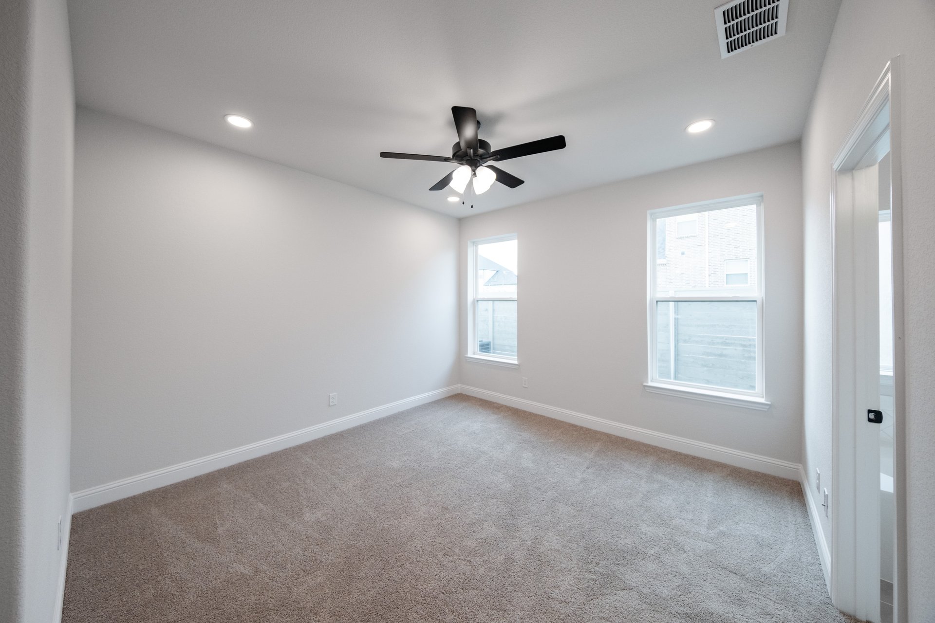 bedroom with carpet and two windows 