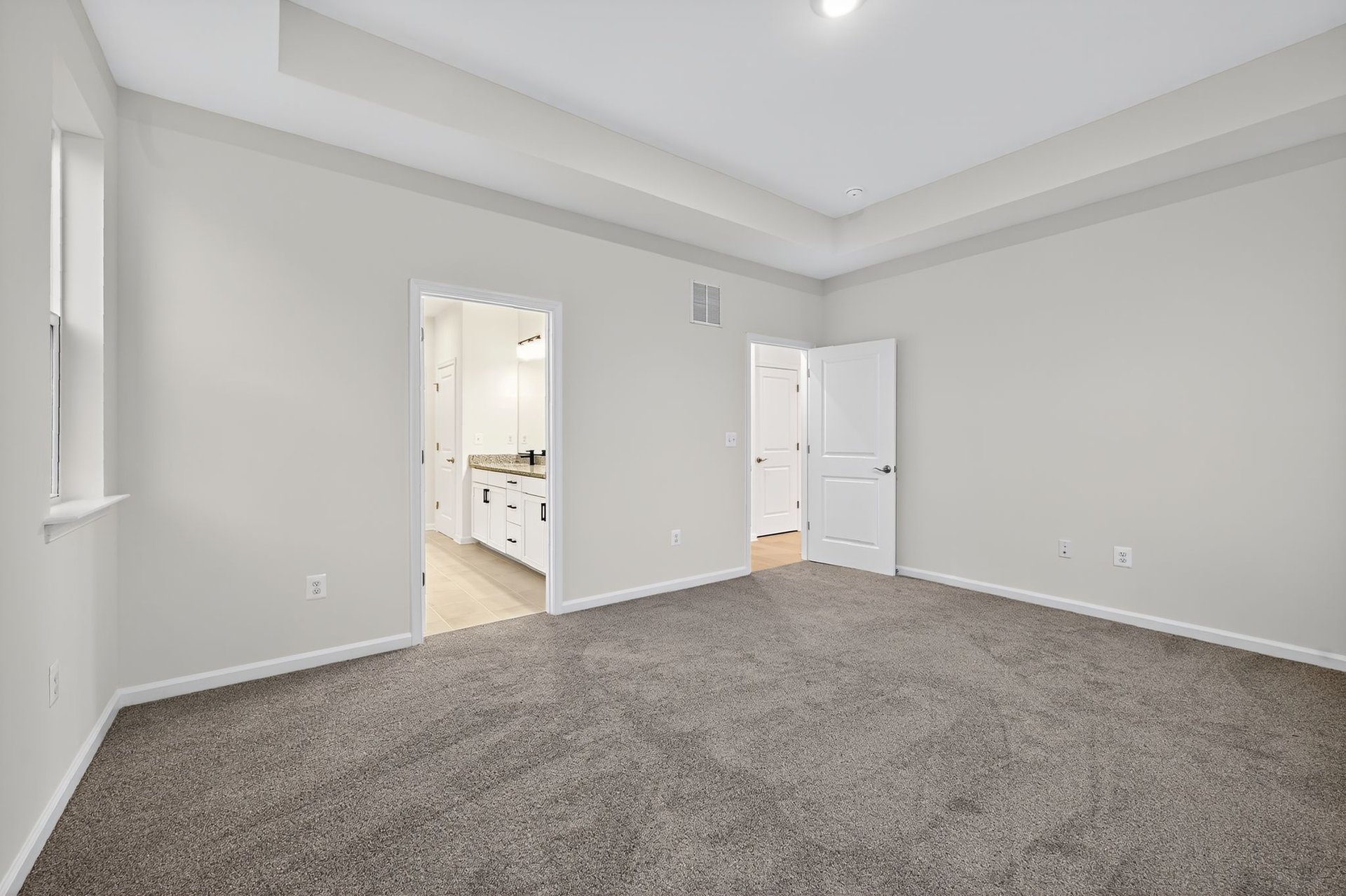 primary bathroom with dual vanities