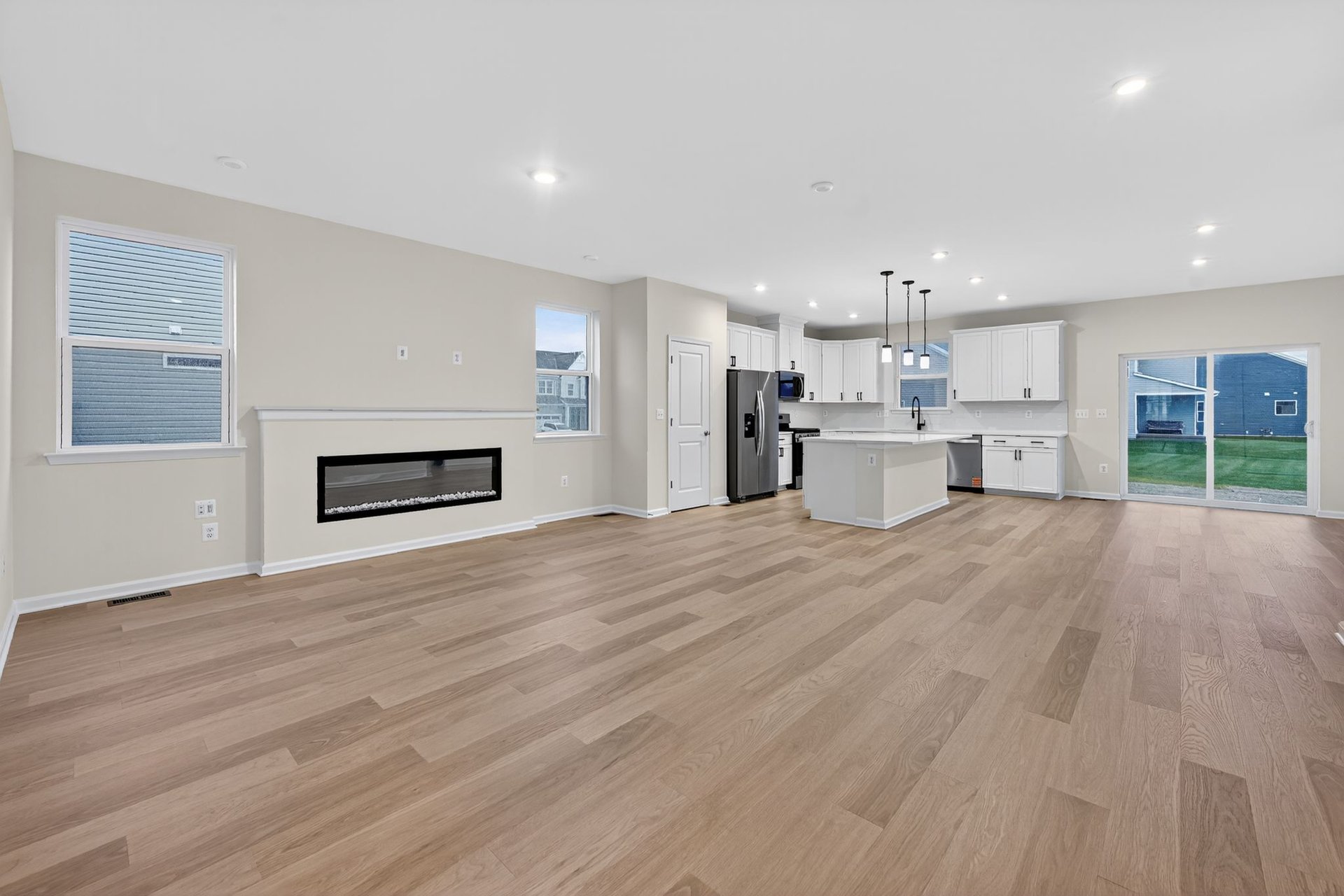 great room with a fireplace and designer flooring