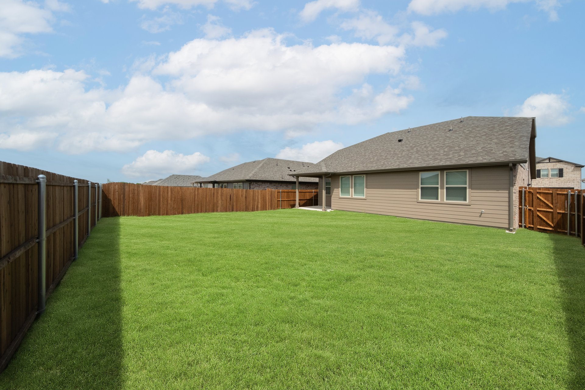 backyard with grass and covered patio