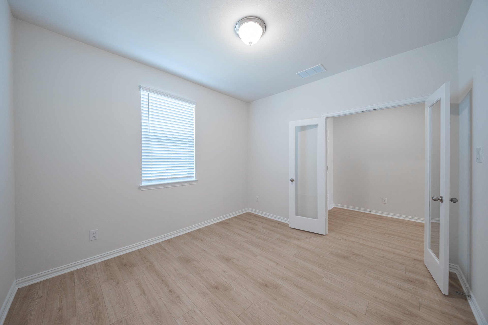 private study with wood floors and windows