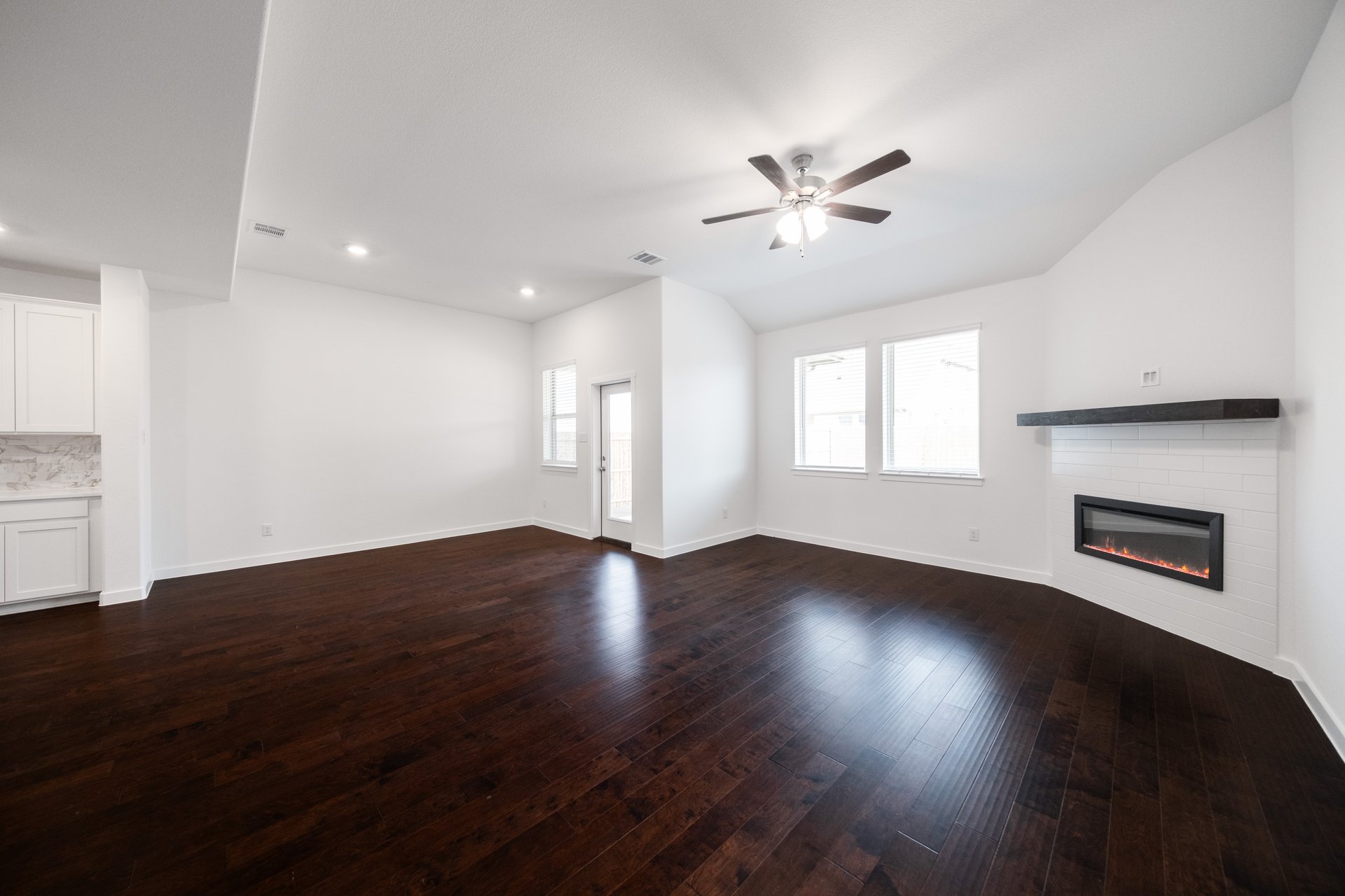 great room with wood flooring and fireplace