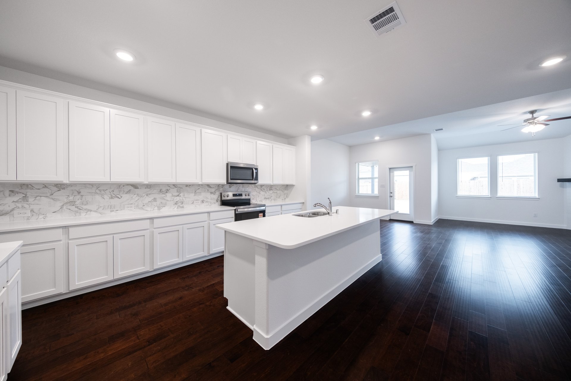 kitchen with large island and white cabinets