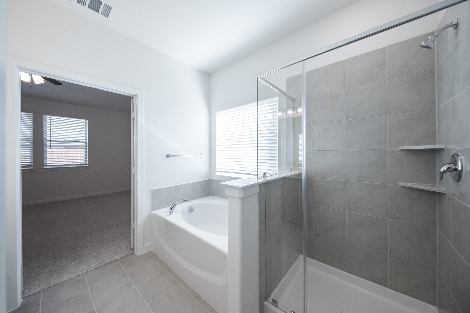 bathroom with large soaking tub and walk-in shower