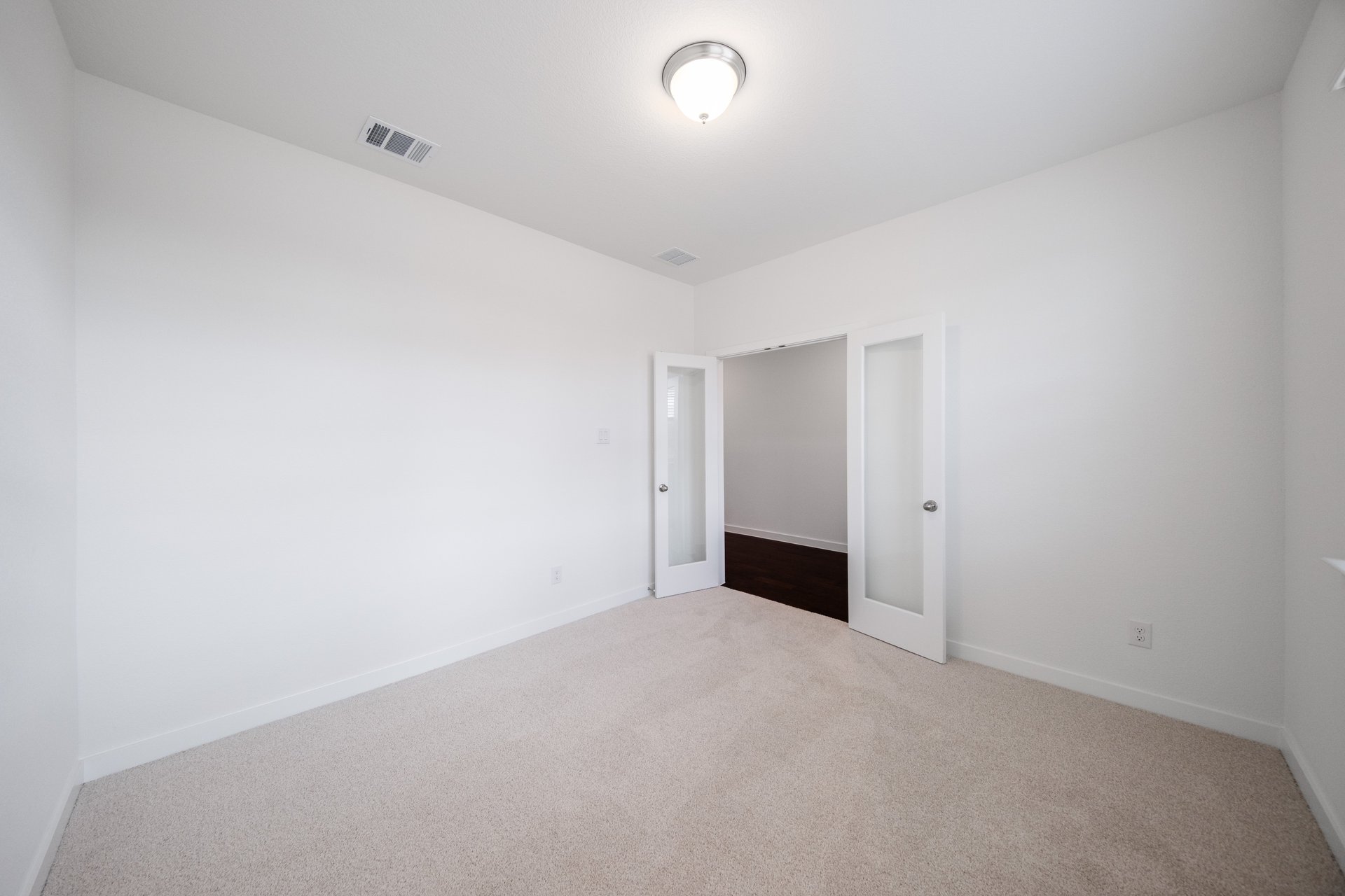 study with carpet and french doors