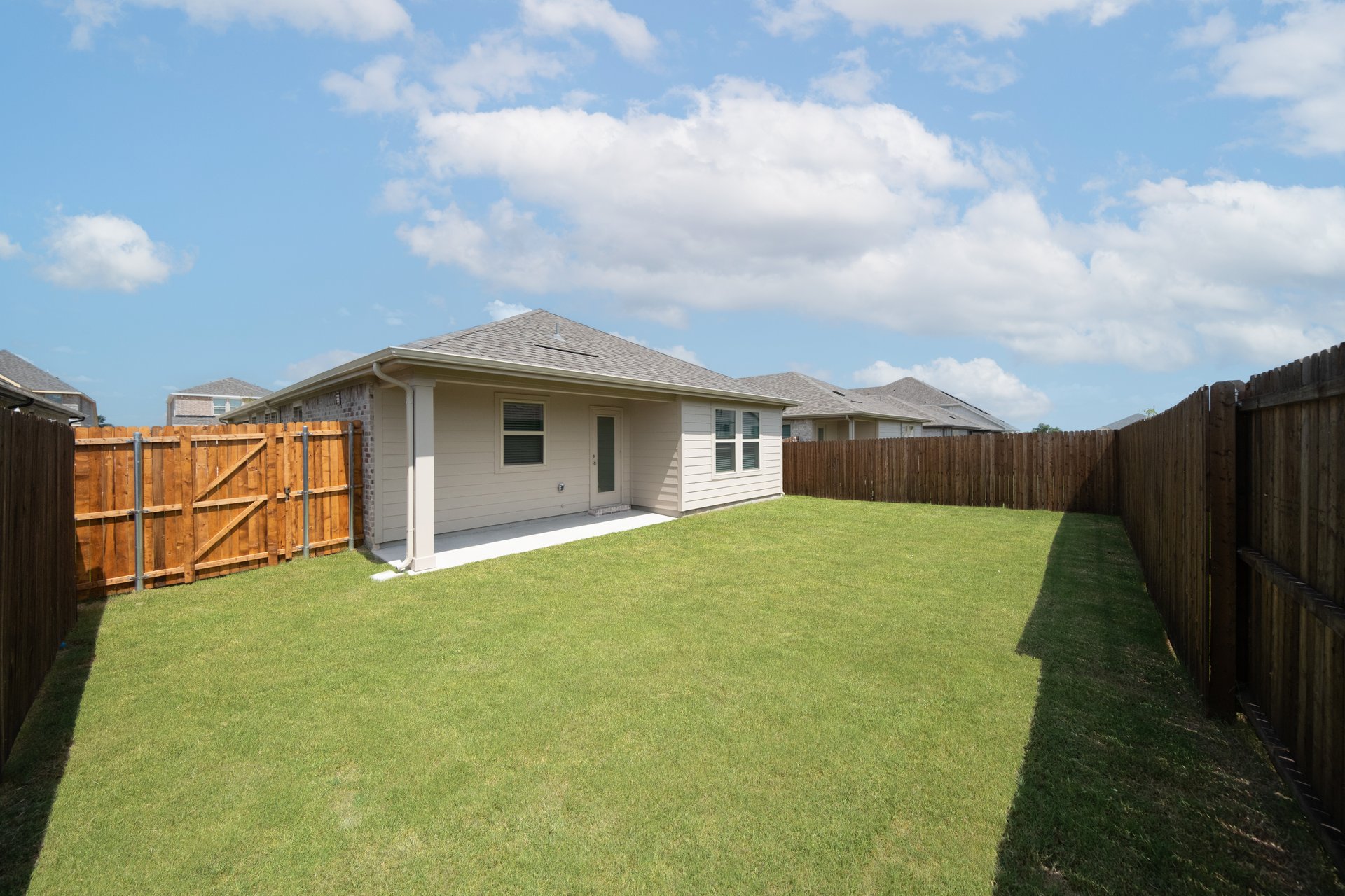 backyard with grass and covered patio