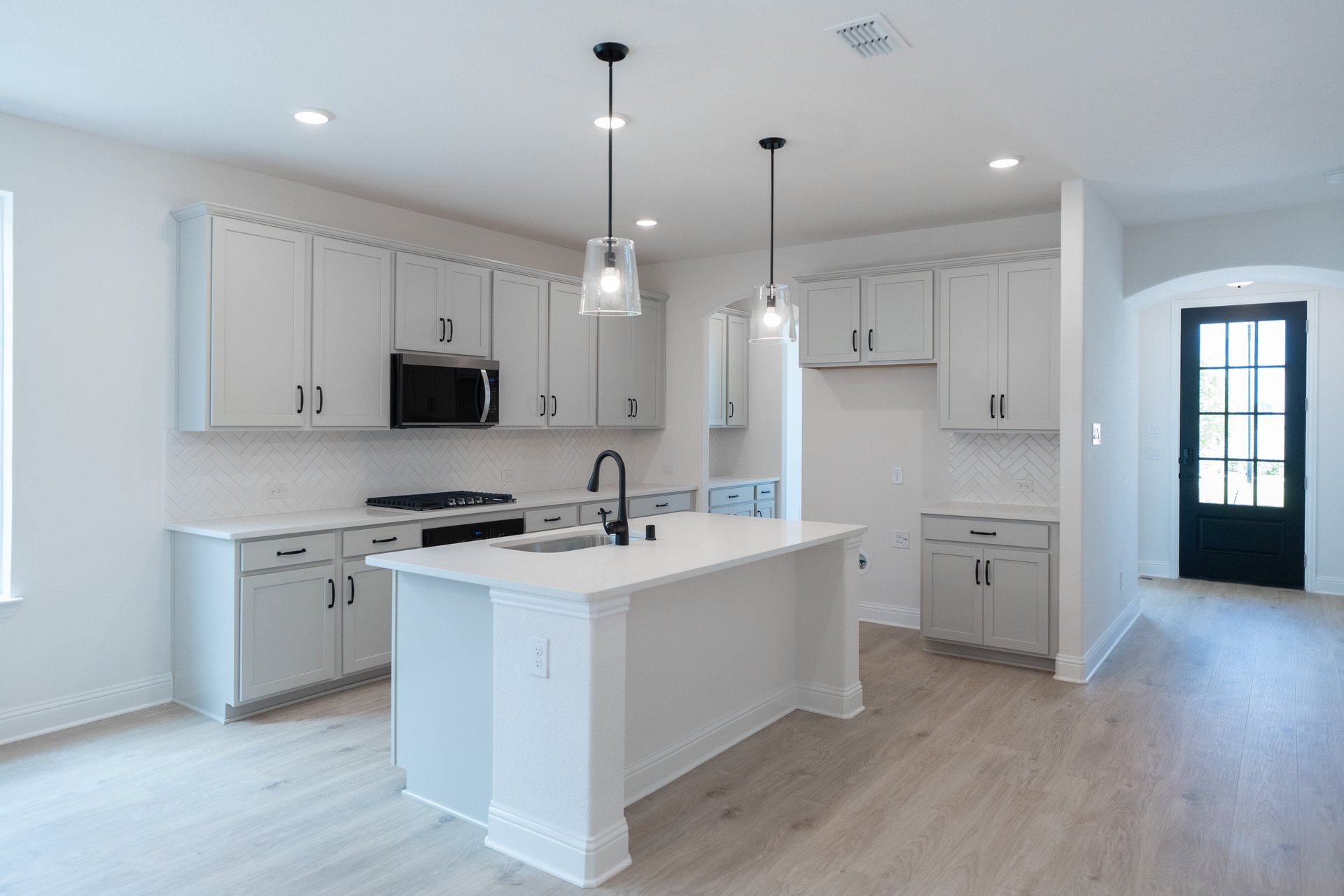 open kitchen with wood floors and island
