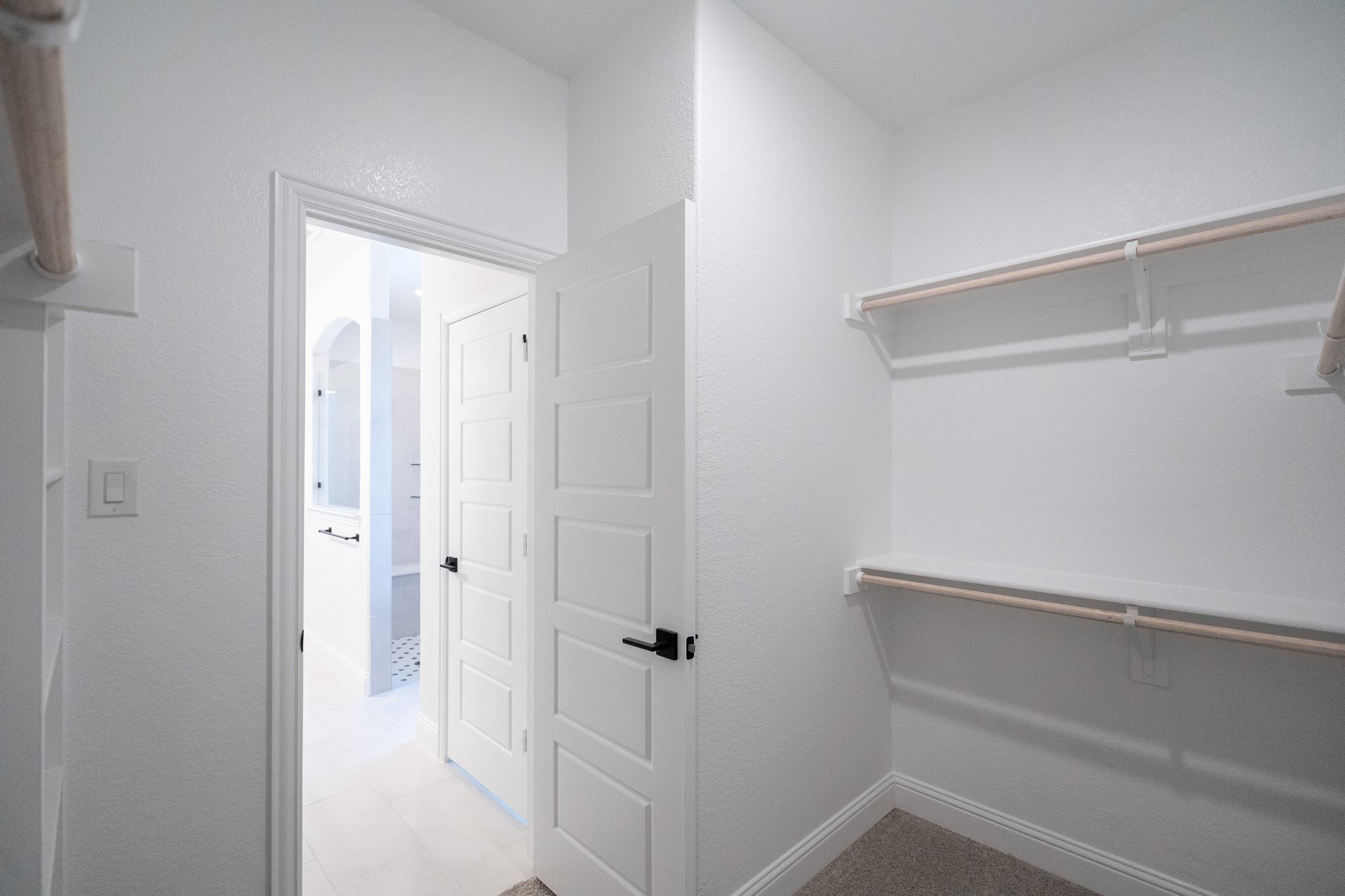 primary bedroom closet with carpet and white shelves