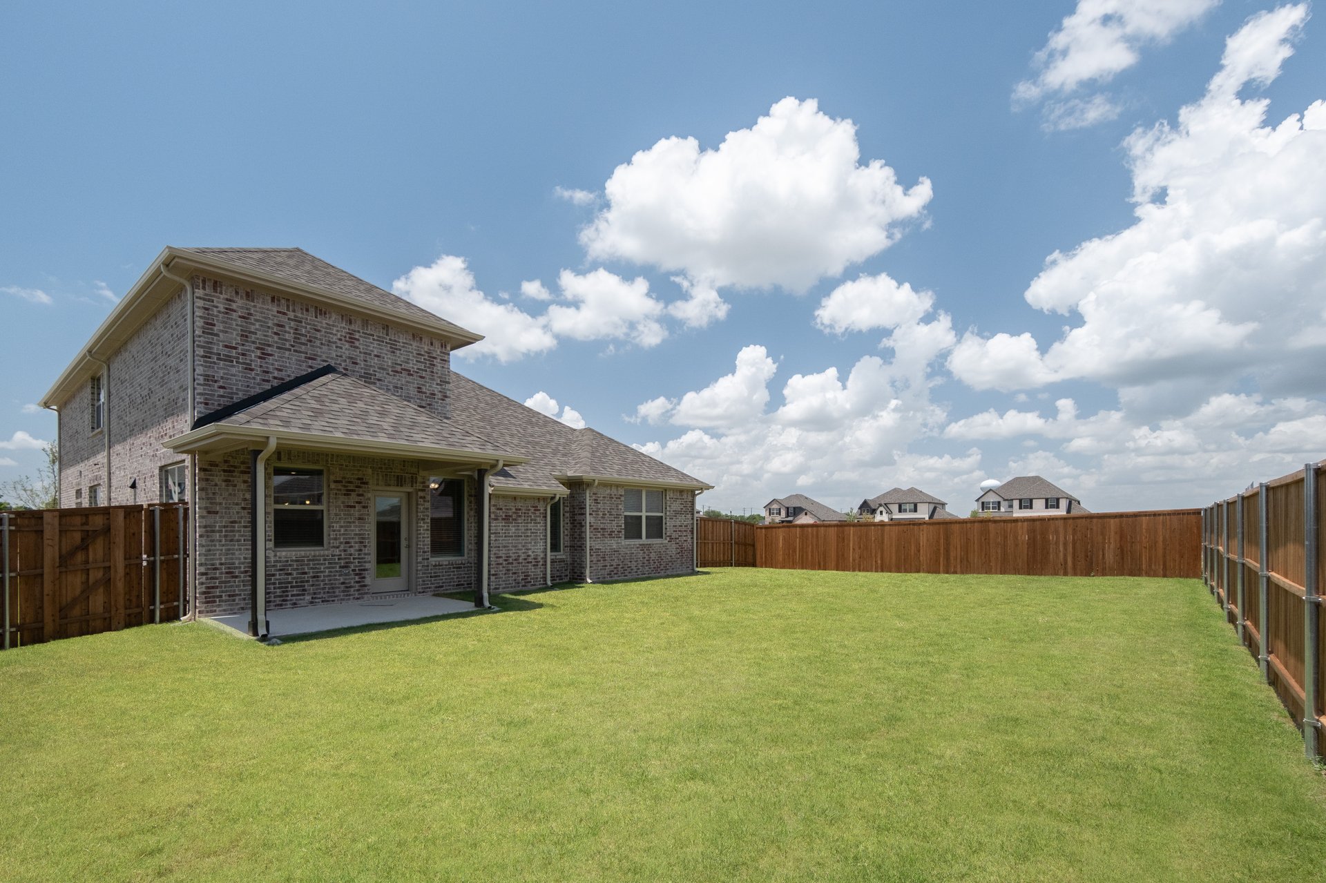 backyard with grass and covered patio